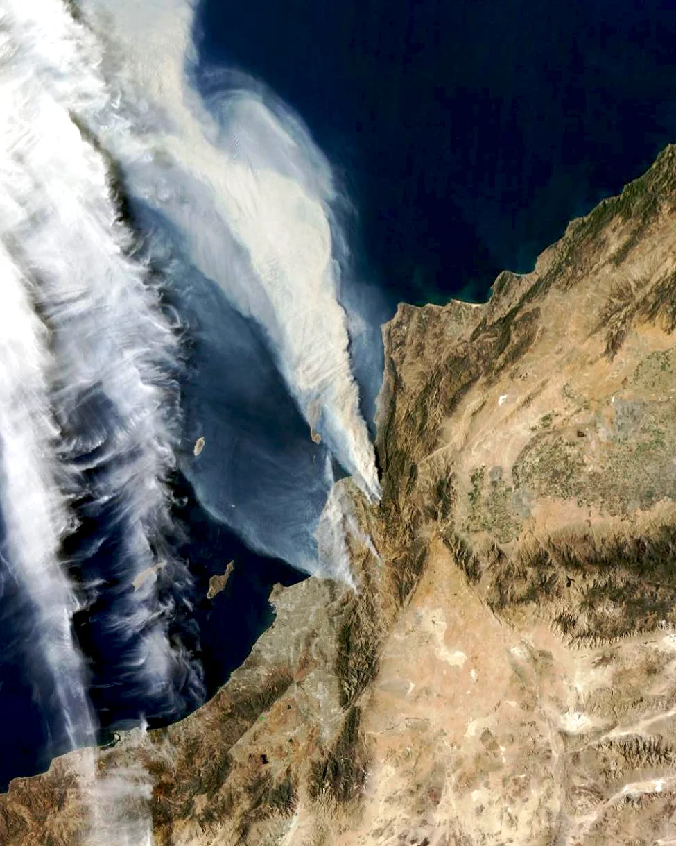 Wildfires, visible at center, are currently burning in Ventura, California. Numerous blazes have already destroyed hundreds of homes and thousands of residents have fled the surrounding areas. The largest fire has expanded to cover an area roughly the size as the city of Orlando. To be very clear, the two white streaks seen here at left are cloud cover, not fires. 34°16′30″N 119°13′40″W Source imagery: NASA Goddard Space Flight Center via the Esri ARCgis Platform