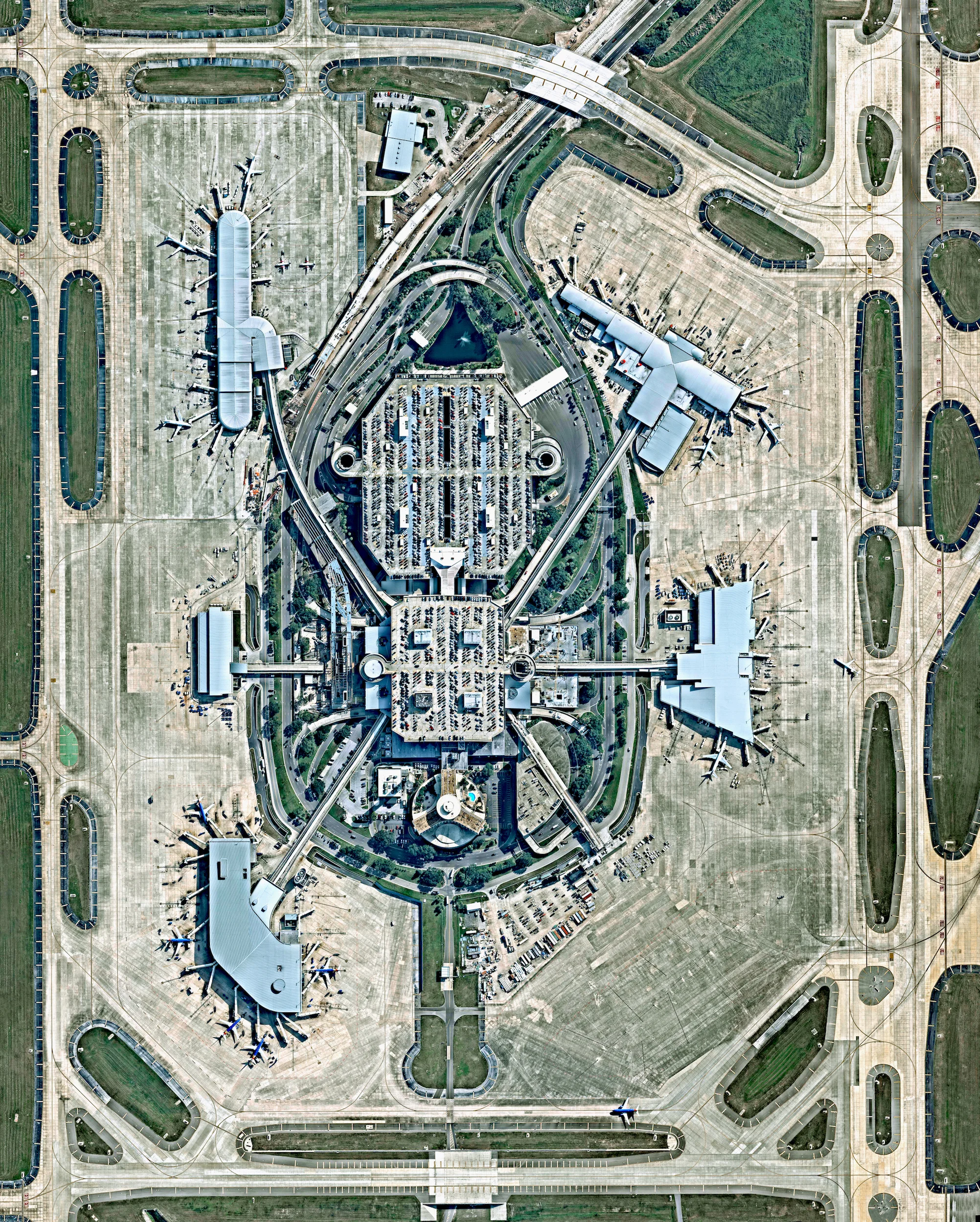 Today I’ll be flying into Tampa International Airport in Tampa, Florida, USA. Designed in the 1960’s, the facility’s Landside/Airside design was the first of its type in the world. In this layout, baggage and ticketing functions take place in a central "Landside Terminal” which is surrounded by four “Airside” satellite terminals where planes embark and disembark. 27°58′32″N 082°32′0″W Source imagery: Nearmap
