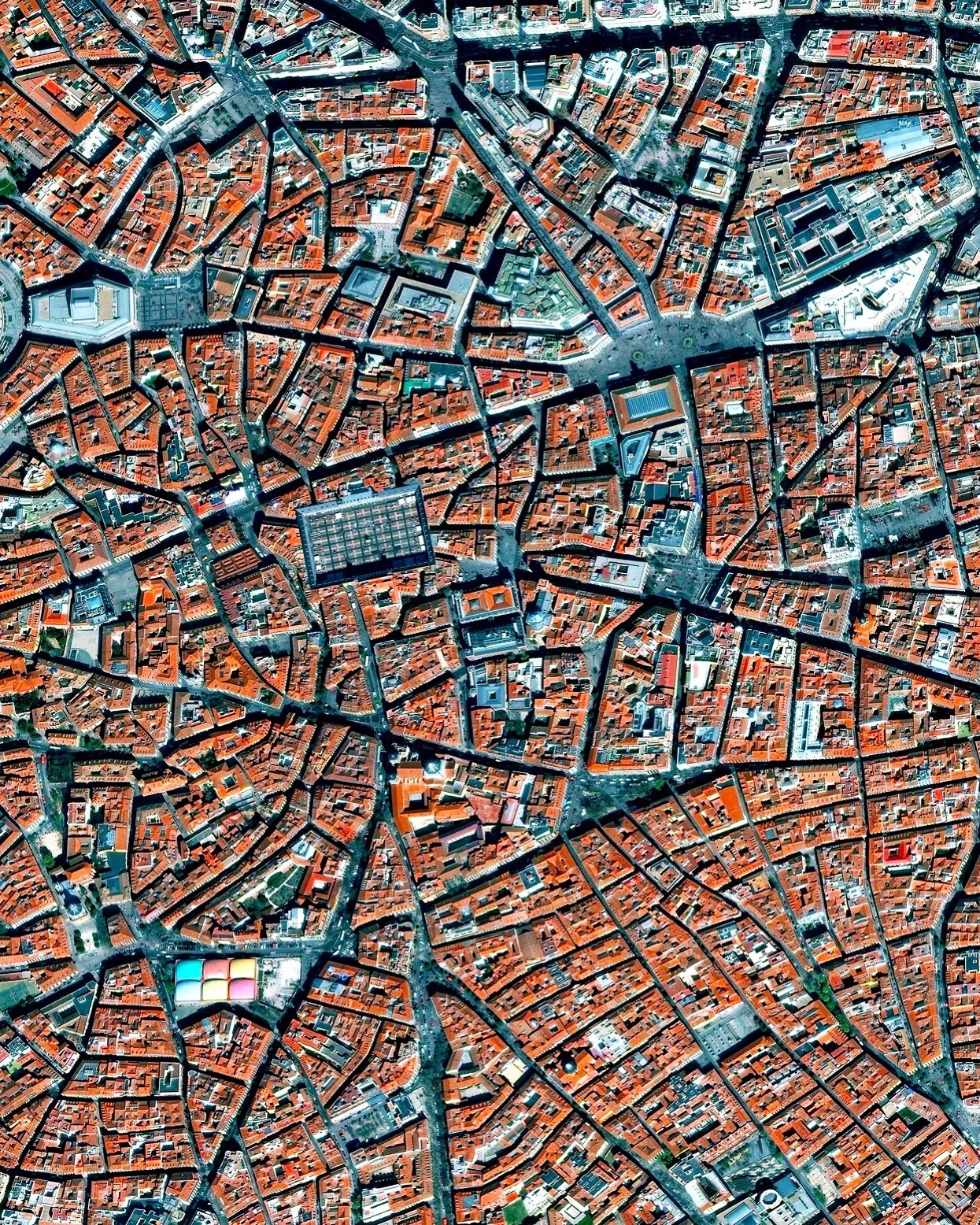 La Latina is a neighborhood located in the center of Madrid, Spain. The area was named after an old hospital of the same name that was founded in 1499. In the lower left of this Overview, you can also see the popular Mercado de la Cebada market, with its six-panel, multi-colored rooftop. 40°24'41.4"N, 3°42'39.5"W Source imagery: DigitalGlobe