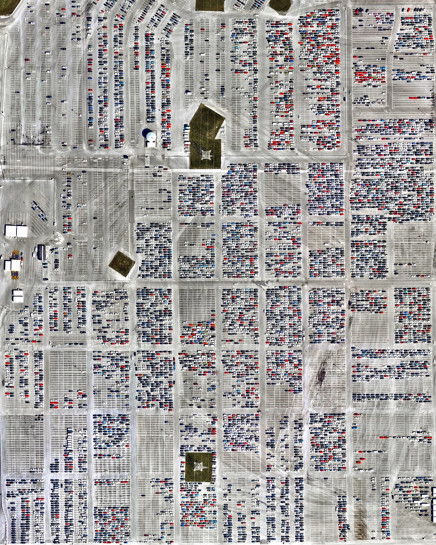 Vehicles await auction on a large lot in Manheim, Pennsylvania. Founded in 1945, this facility is the world’s largest wholesale auto auction, handling around 8 million vehicles per year at more than 100 locations worldwide. The lot seen in this Overview is approximately 500 acres (200 hectares) in size. 40°08'25.3"N, 76°23'48.4"W Source imagery: Nearmap