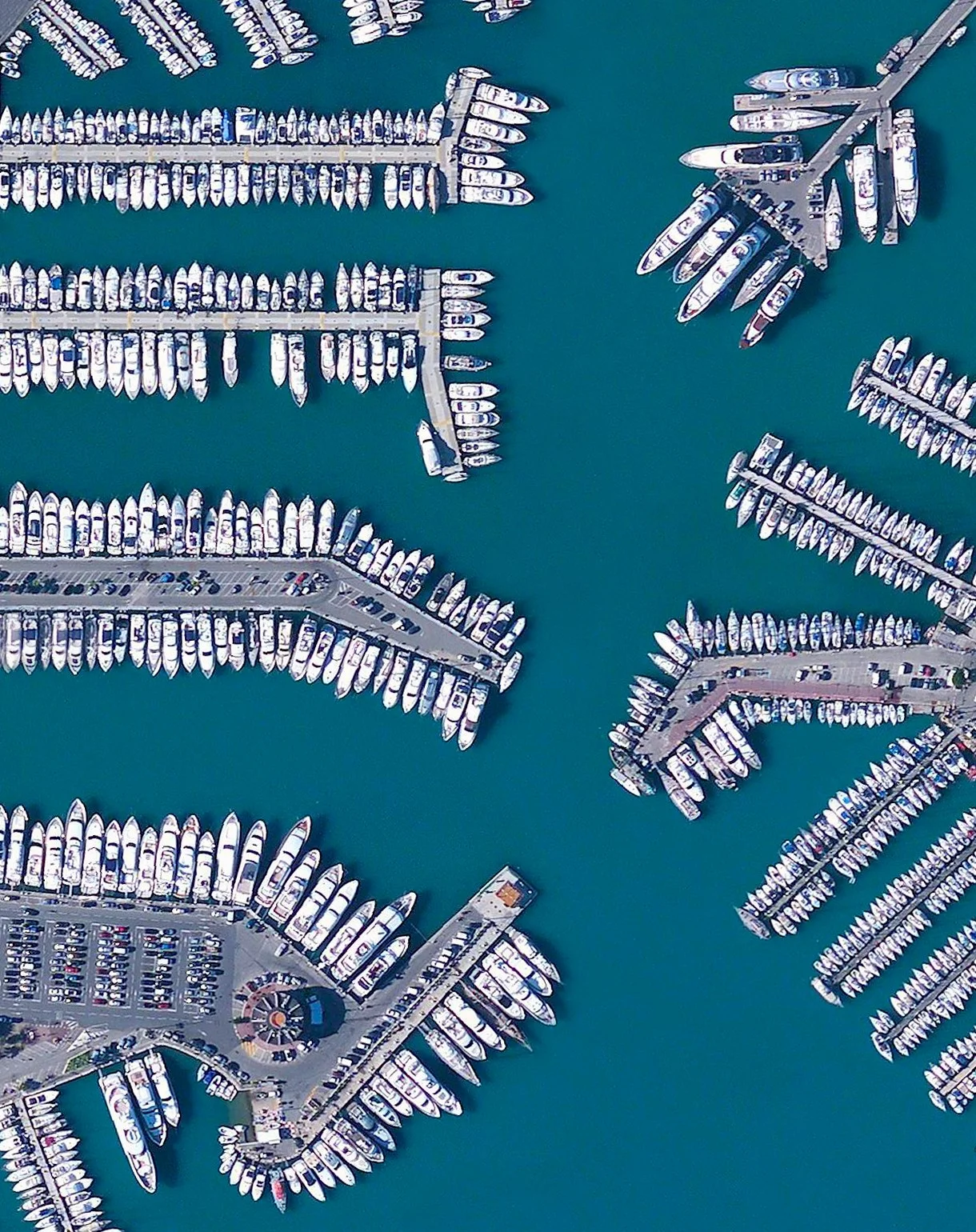 Massive yachts are docked in the stunning blue water of Port Vauban, a harbor located in Antibes on the French Riviera. The facility is the largest marina on the Mediterranean Sea in terms of total tonnage of the boats that are moored here. 43°35'11.6"N, 7°07'33.1"E Source imagery: DigitalGlobe