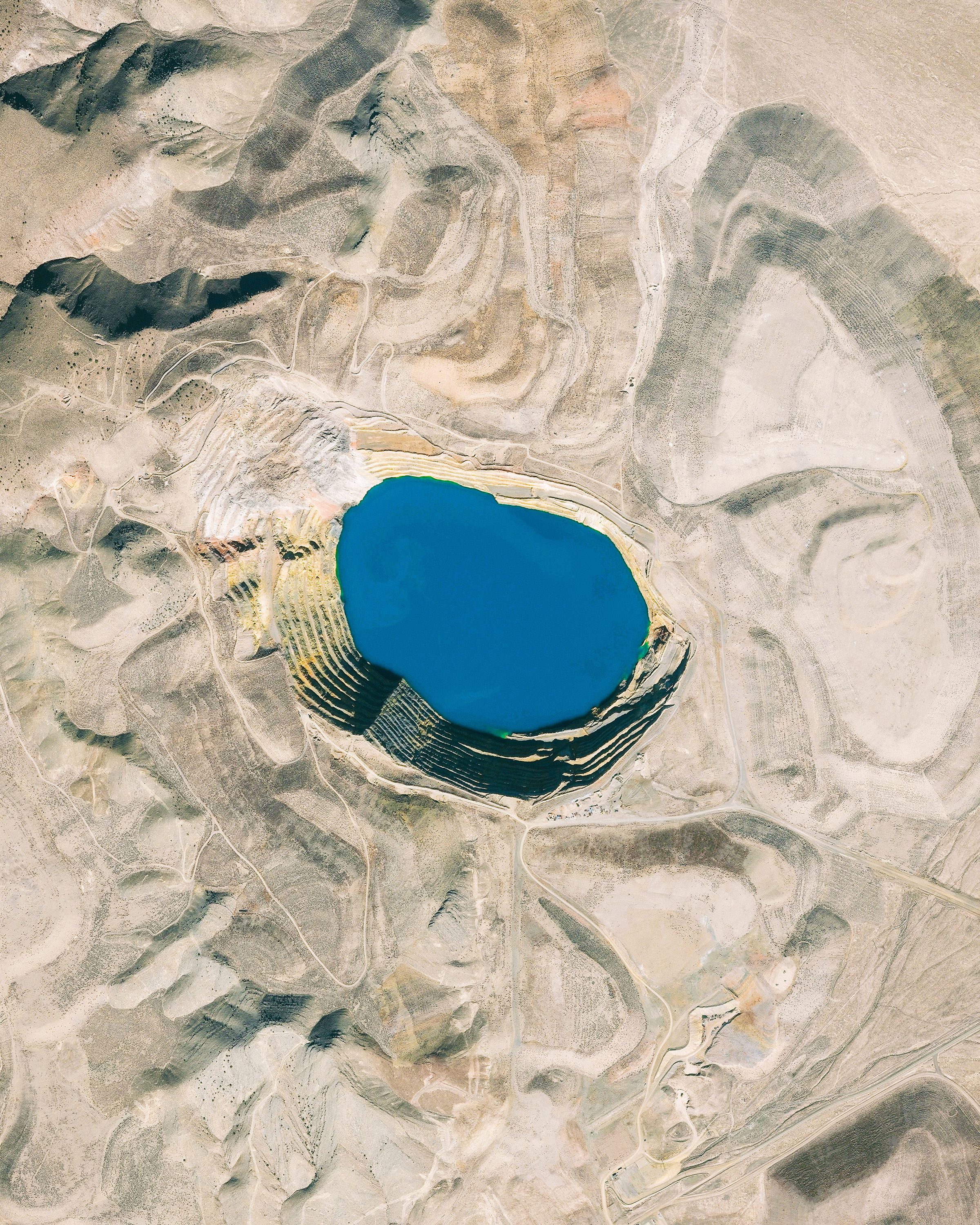 Vivid blue water fills an open-pit mine near the town of Battle Mountain in Lander County, Nevada. Founded in 1861, Lander County made its way onto the map as copper and gold mining boomed there throughout the late 19th century. Today, fewer than 6,000 people live in the 5,500-square-mile county. 40°20'17.4"N, 117°12'08.7"W Source imagery: DigitalGlobe