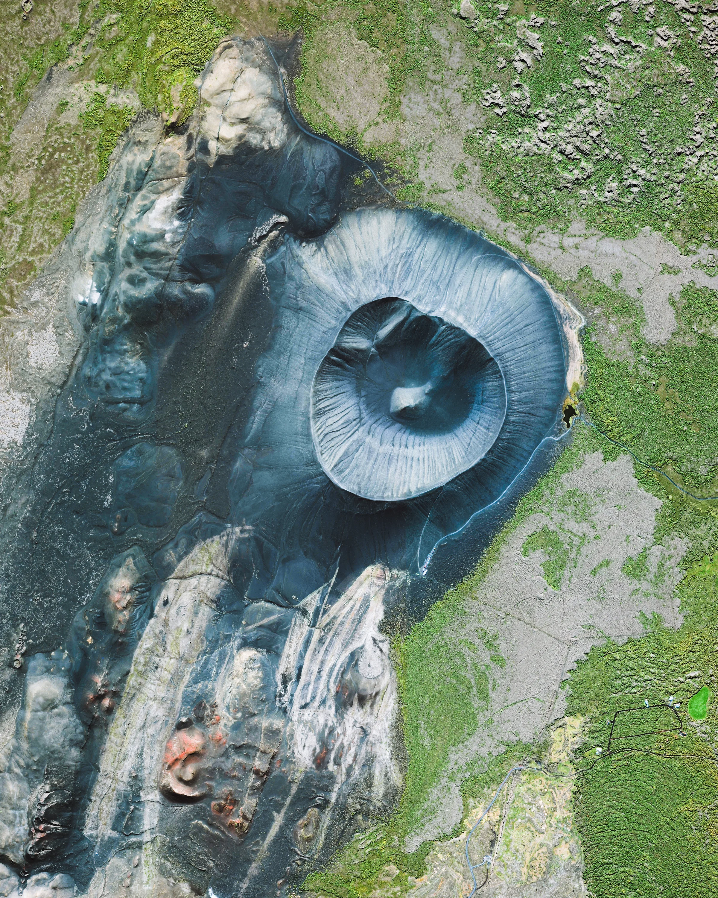 Hverfjall is a tephra cone, or tuff ring, volcano located near the eastern shore of Lake Myvatn in northern Iceland. It erupted in 2500 BP, leaving behind a massive crater more than half a mile (1 km) in diameter. Hverfjall is just 1,300 feet (396 m) high, allowing tourists and hikers to scale its slopes and walk along the crater’s rim. 65°36'19.3"N, 16°52'21.1"W Source imagery: DigitalGlobe