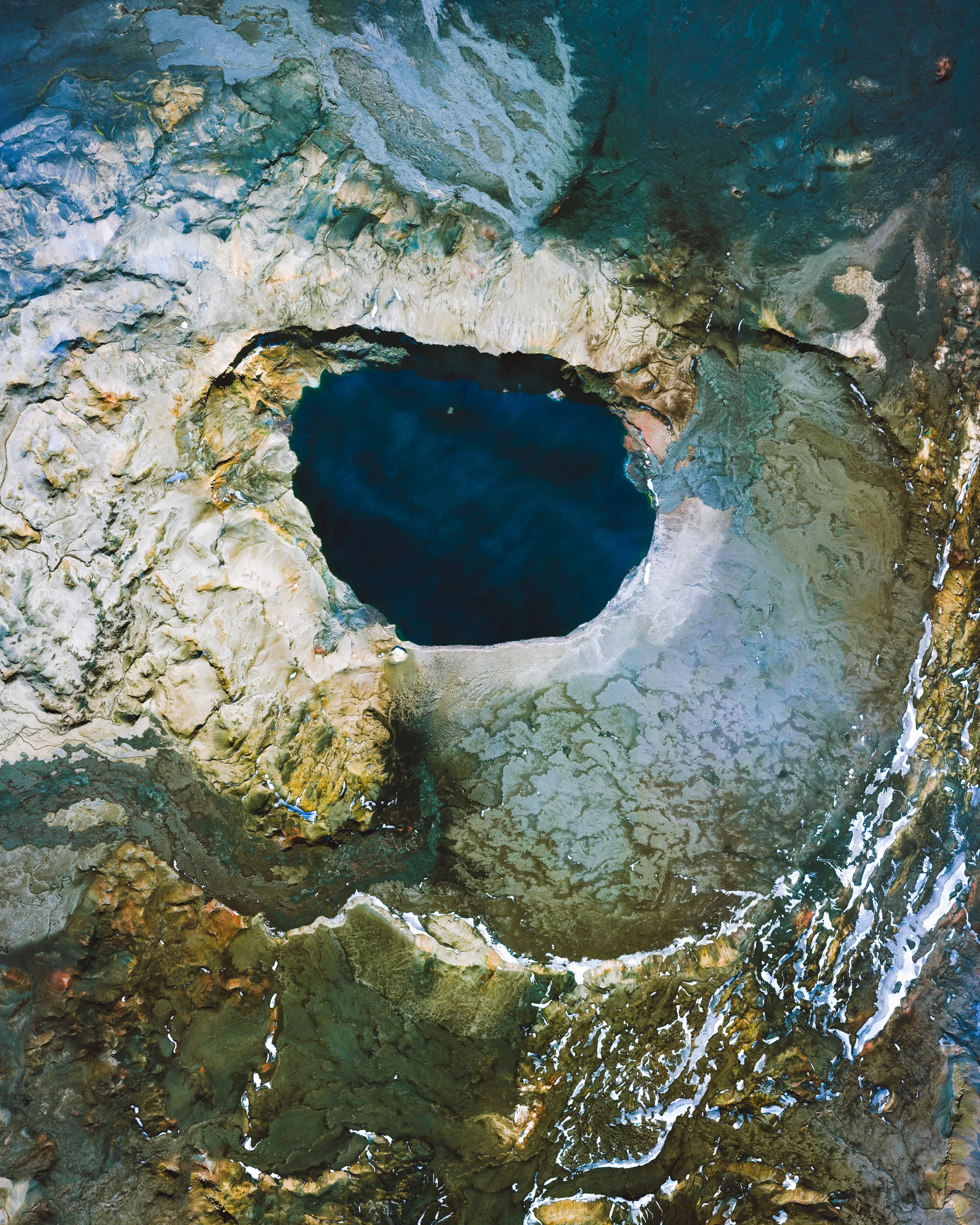 Askja is a caldera located in a remote part of the central highlands of Iceland. Calderas are large, cauldron-like hollows that form after the magma chamber of a volcano is evacuated and the earth above collapses into it. Askja is roughly 2.8 miles (4.5 km) in diameter and is accessible only a few months out of the year — in fact, the region in which it is located is so remote and otherworldly, it was used as a training site for NASA's Apollo program to prepare astronauts for lunar missions. 65°01'48.0"N, 16°45'00.0"W Source imagery: DigitalGlobe