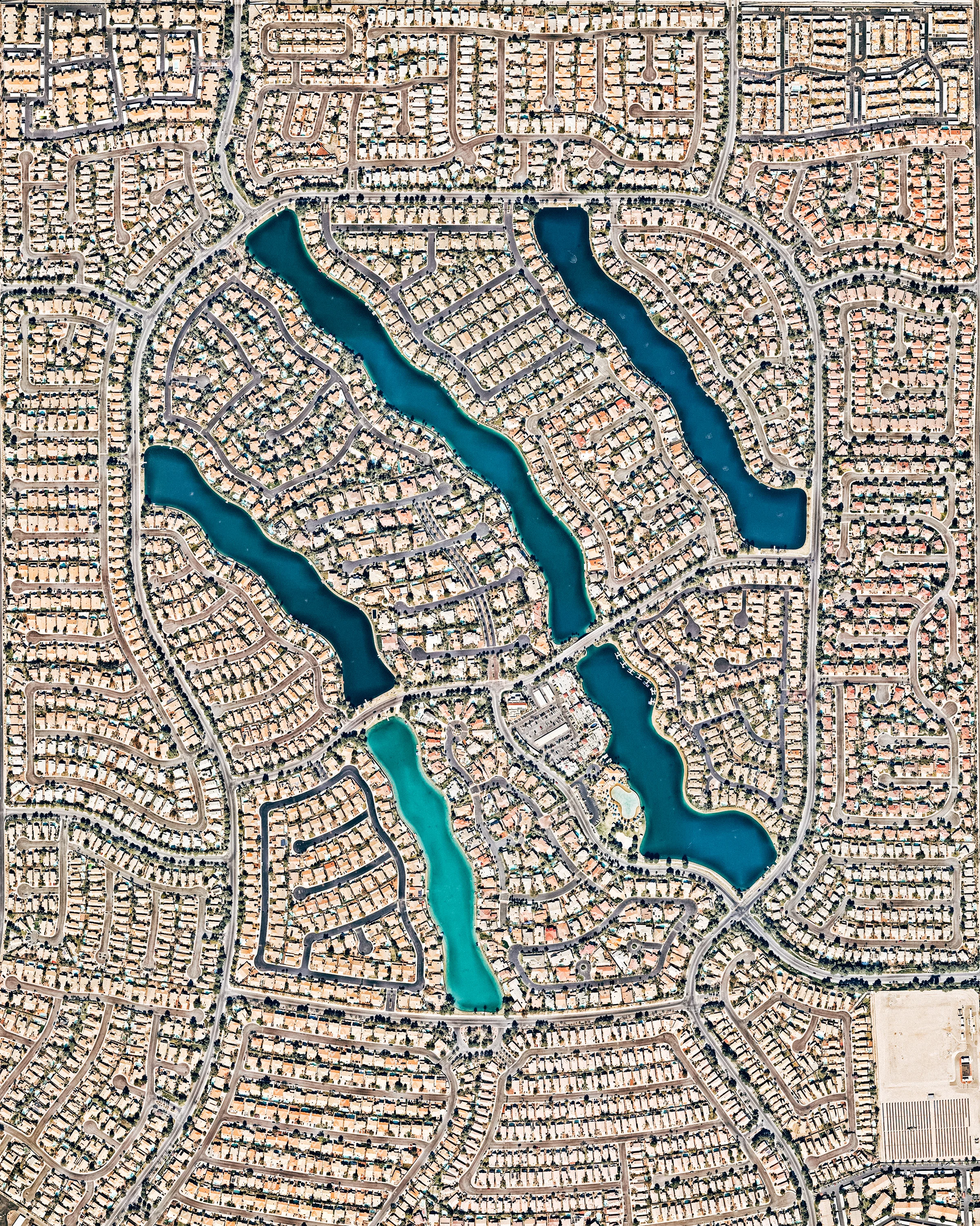 Desert Shores is a 682-acre master planned community in northwest Las Vegas, Nevada. Constructed in 1988, it has more than 3,300 housing units ranging from condominiums to large, custom-built homes. At the center of Desert Shores are four man-made lakes, the largest of which — Lake Jacqueline — is flanked by the other three. 36°12'43.9"N, 115°16'08.1"W Source imagery: Nearmap