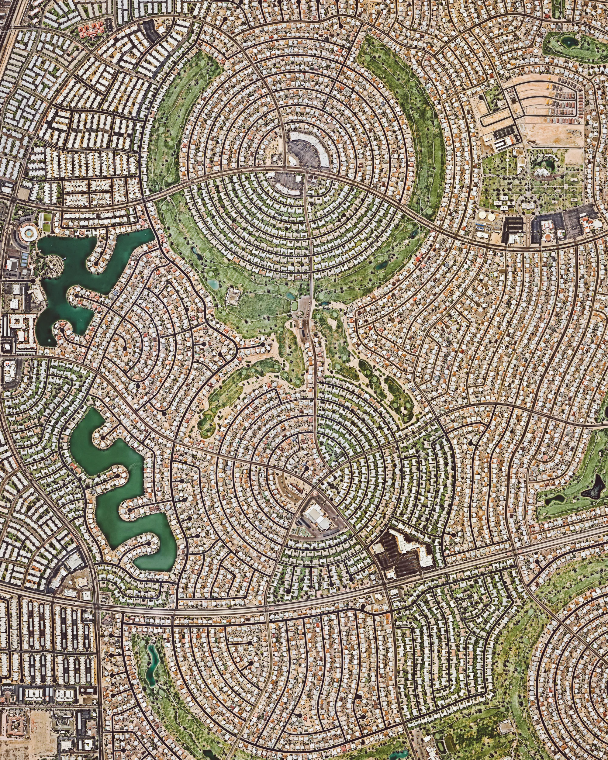 Sun City, Arizona, is a retirement community and census-designated place located within the Phoenix metropolitan area. It has a population of roughly 38,000 and an adjoining sister city — Sun City West — which houses an additional 25,000 residents. When Sun City opened on January 1, 1960, it attracted a crowd of more than 100,000 onlookers and the "futuristic development" was featured on the cover of Time magazine. 33°37'05.9"N 112°16'51.3"W Source imagery: Nearmap