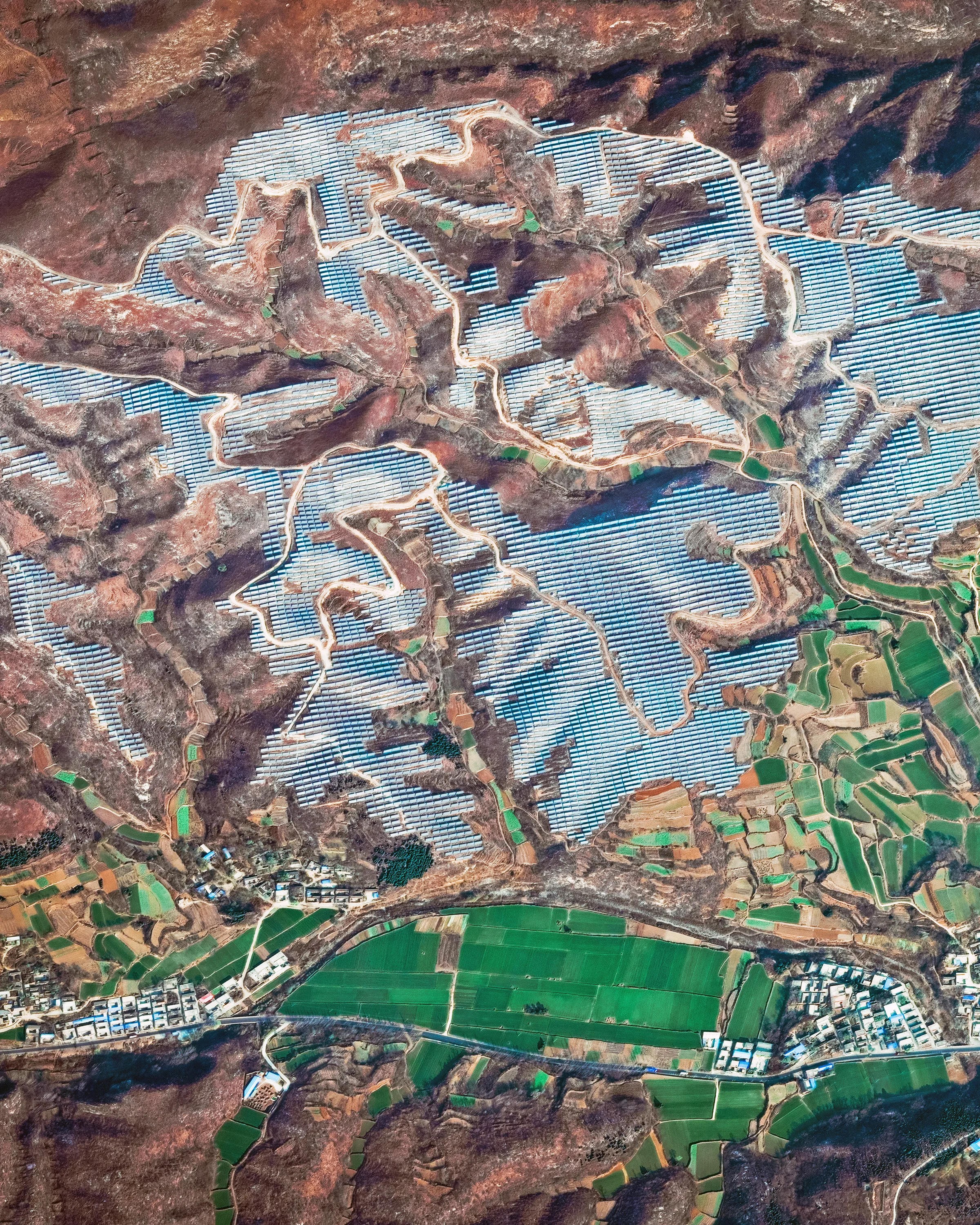 Solar panels cover the hillsides of Tumencun, a small township in China's Henan Province. In 2017, China accounted for more than half of the world's investment in solar energy, putting forth $86.5 billion of a $160.8 billion global total. With these funds, China added an estimated 53 gigawatts of new solar capacity — more than all other countries combined. 35°47'27.1"N, 114°09'22.2"E Source imagery: DigitalGlobe