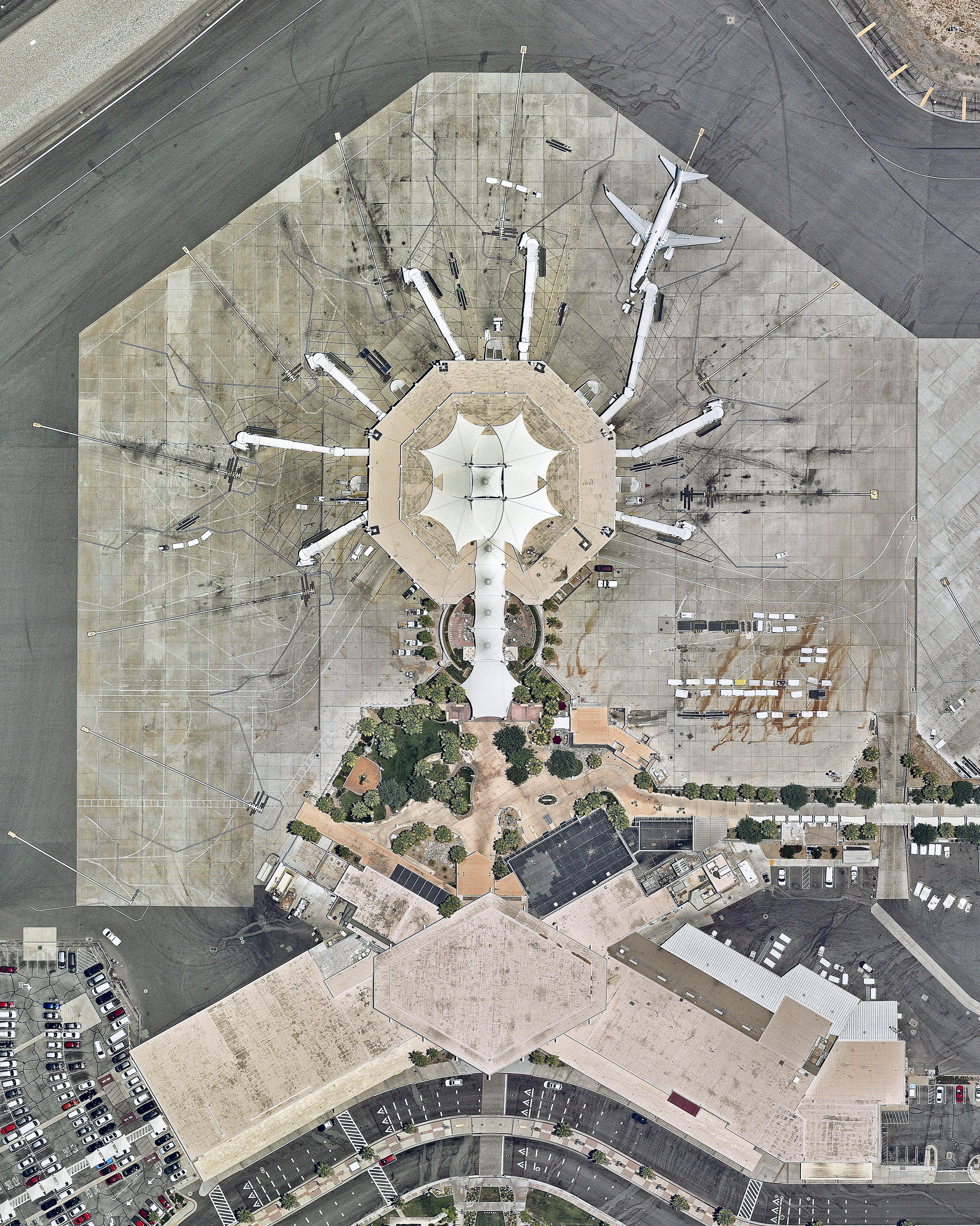 A single airplane waits at the international terminal of Palm Springs International Airport in Palm Springs, California. The airport is highly seasonal, operating a majority of its flights in the winter, and it has been called one of America's most “stress-free" airports. In 2017, it handled slightly more than 2.1 million passengers across 12 airlines. 33°49'47.0"N, 116°30'24.0"W Source imagery: Nearmap