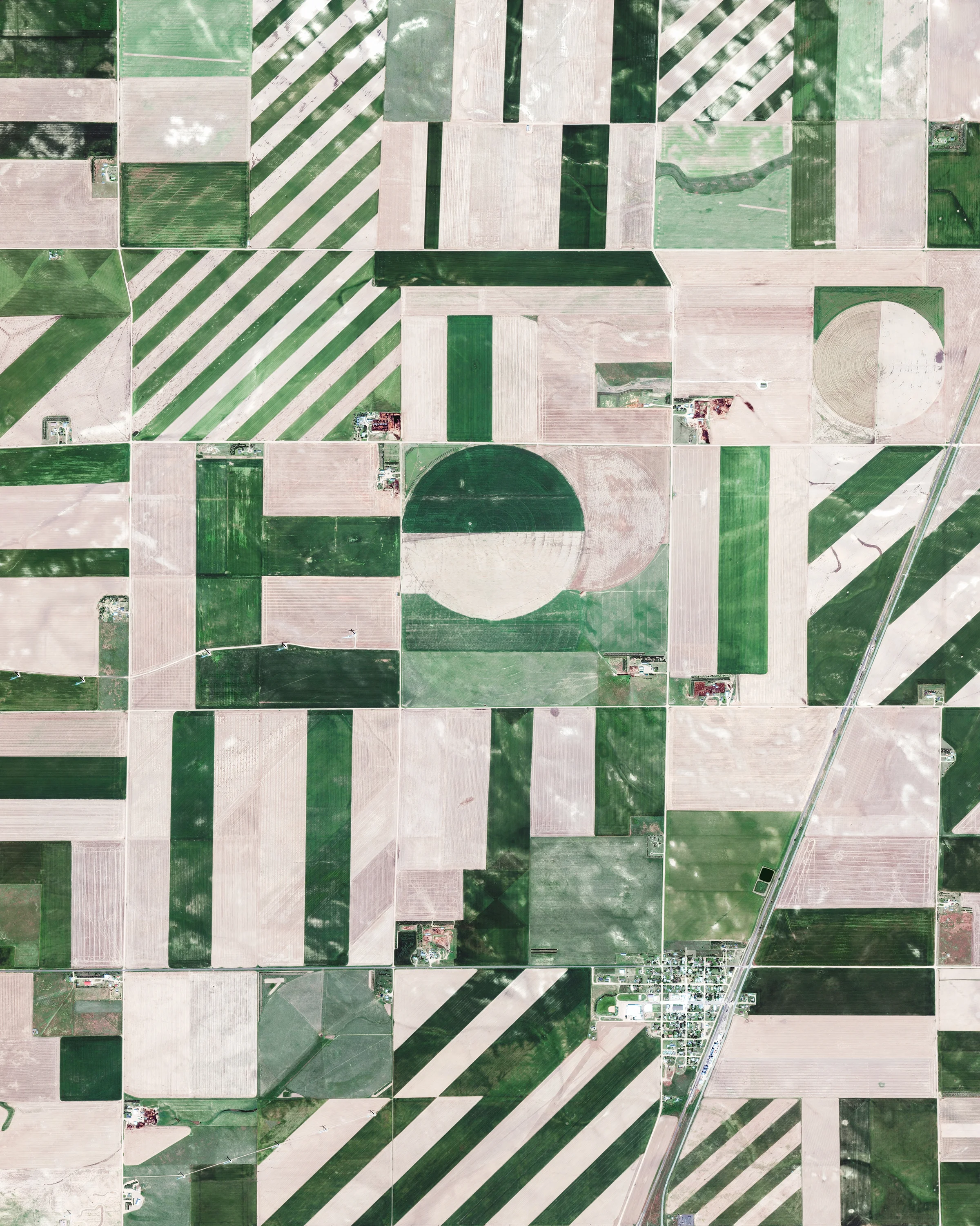 Check out this Overview, which shows some interesting patterns of farmland in Logan County, Colorado. Much of the county's 1,845 square miles (4,780 sq. km) is used for farming, ranching or related activities, making it one of the most productive agricultural counties in the state. Shown in the bottom half of this image is the small town of Peetz, which has more wind turbines (300) than residents (238). 40°59'17.0"N, 103°07'41.2"W Source imagery: DigitalGlobe