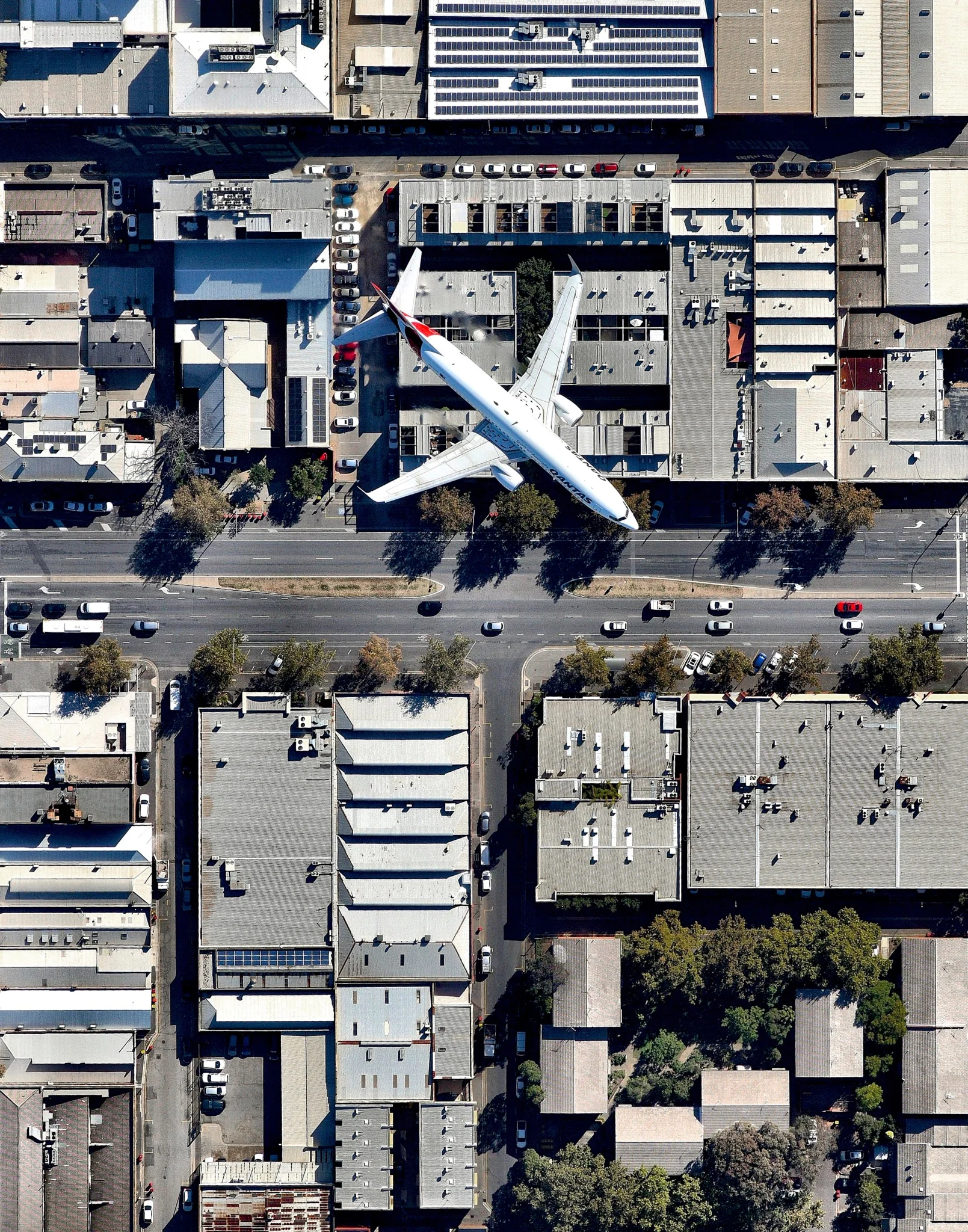 A Qantas jet flies over Wakefield Street in Adelaide, South Australia, after taking off from Adelaide Airport. Adelaide is the fifth-largest city in Australia, and its airport is the country’s fifth-busiest. Between 2016 and 2017, it served roughly 8 million passengers and saw an 11% increase in international travelers. 34°55'41.2"S, 138°36'25.5"E Source imagery: Nearmap