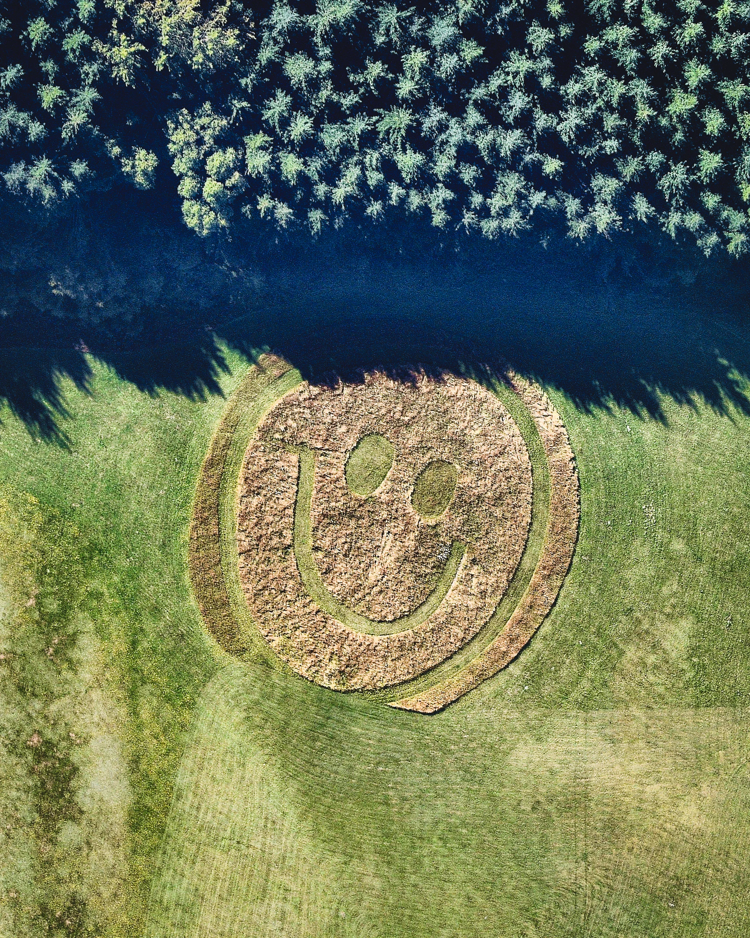 A grass-formed smiley face greets gliders on the grounds of the Infinity Paragliding School in Queenstown, New Zealand. Located on the South Island among several mountain ranges, Queenstown is known for its adventure tourism. In fact, it boasted 220 adventure tourism activities in 2012, including skiing, snowboarding, jet boating, whitewater rafting, bungy jumping and — of course — paragliding, among others. 44°56'23.1"S, 168°46'52.0"E Source imagery: Nearmap