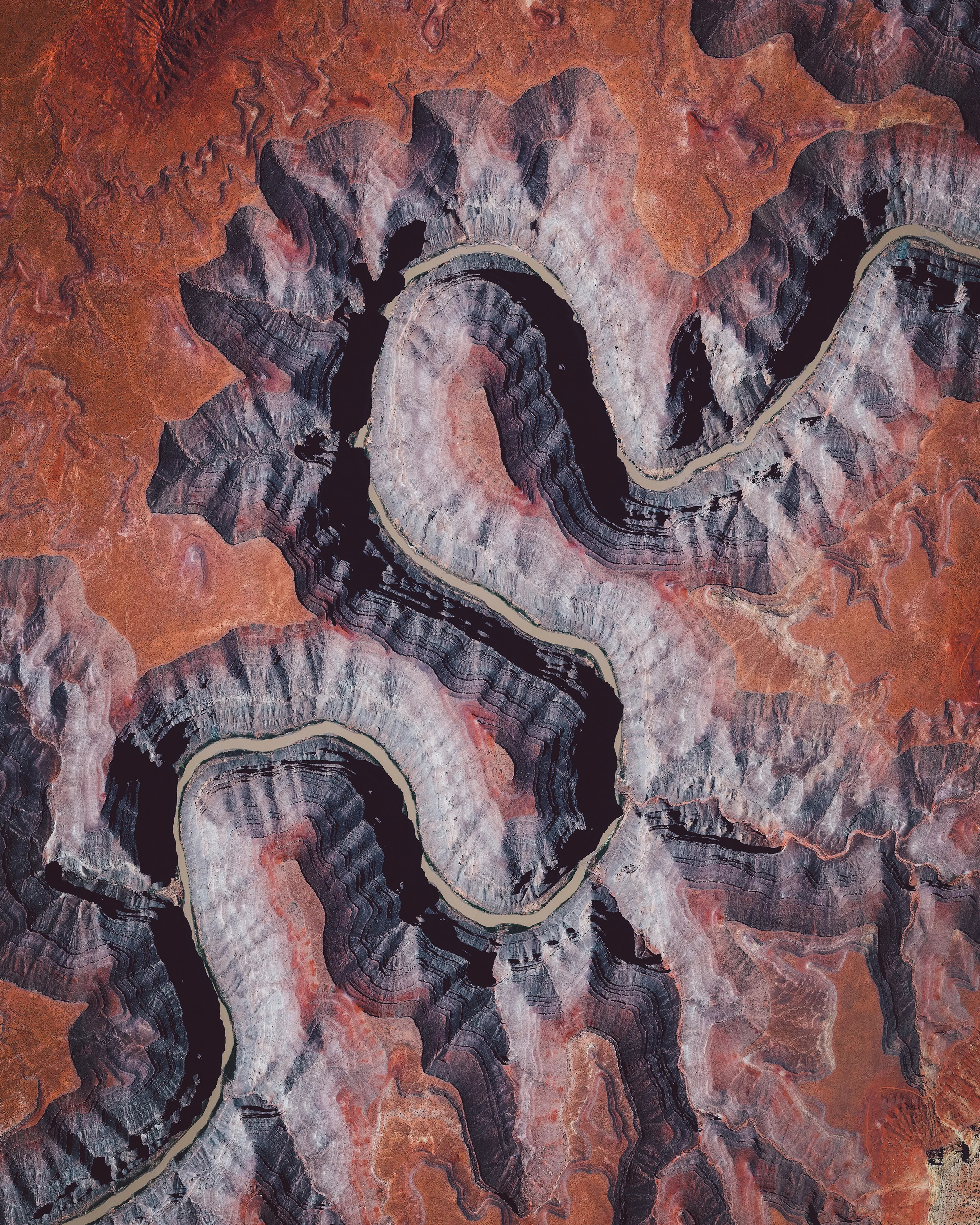 In this Overview, the San Juan River is shown meandering through southeastern Utah, not far from Goosenecks State Park. It is a major tributary of the Colorado River and provides drainage to the Four Corners region of Colorado, New Mexico, Utah and Arizona. The San Juan is one of the muddiest rivers in North America, carrying an average of 25 million U.S. tons of silt and sediment each year. 37°12'22.3"N, 109°59'44.1"W Source imagery: DigitalGlobe