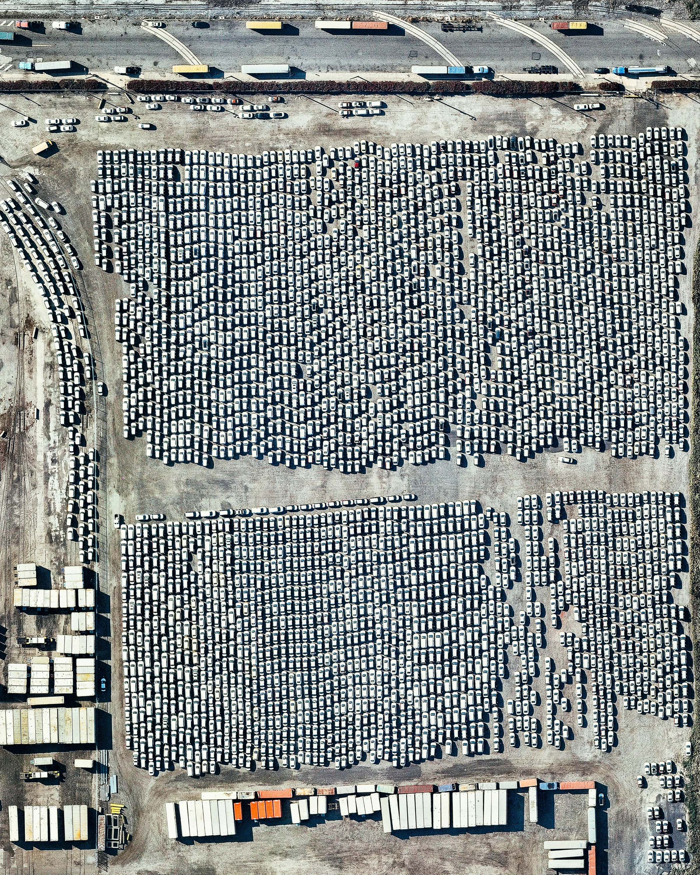 Thousands of automobiles await shipment and distribution at the Philadelphia Auto Processing Facility in South Philadelphia, Pennsylvania. Located on the Delaware River, this 84-acre (34-hectare) facility handles both imports and exports. With connections to Interstates 95 and 76 and two large railways, it is a major supply chain hub for the U.S. automobile industry. 39°54'31.9"N, 75°08'12.5"W Source imagery: Nearmap