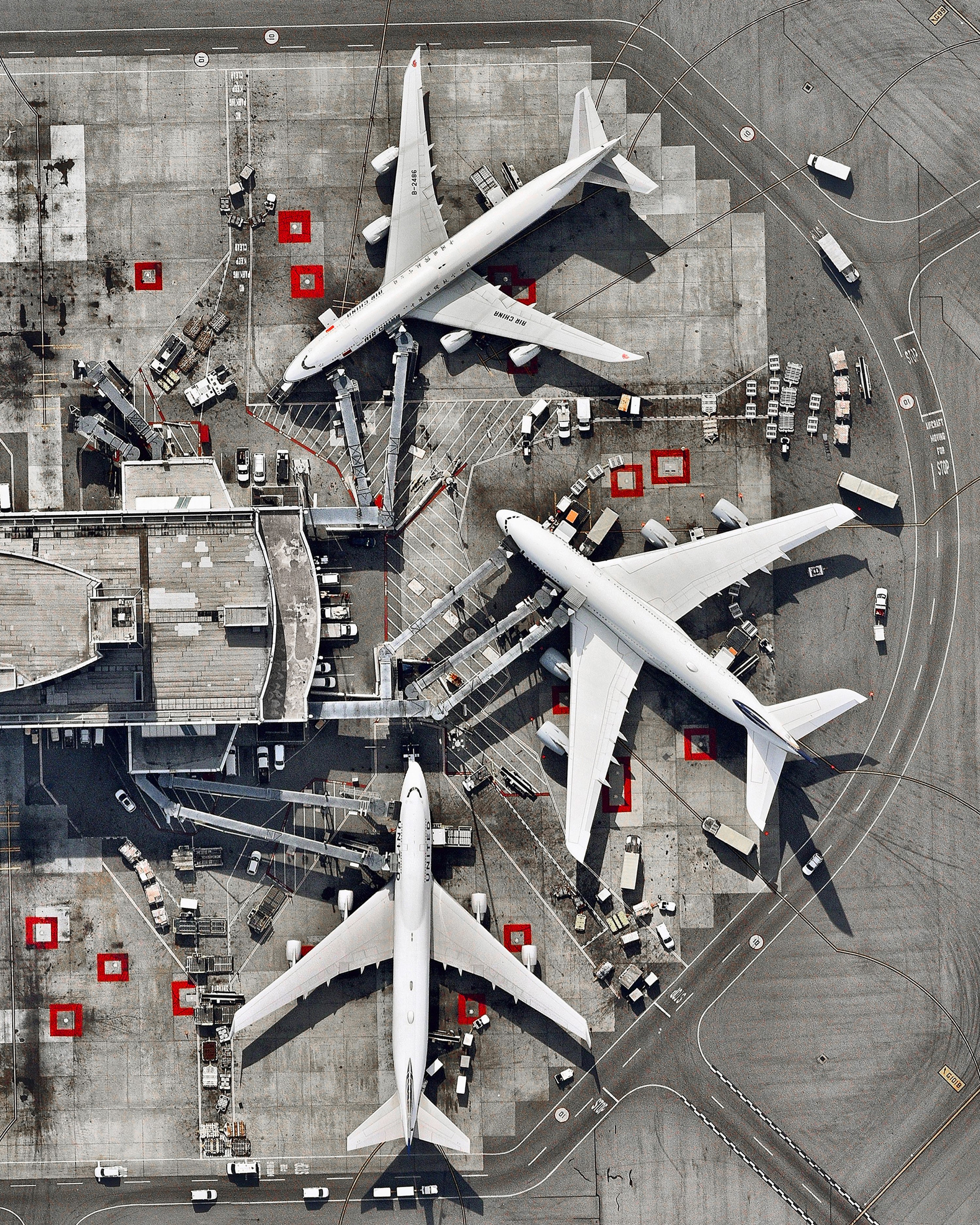 Three massive airplanes are docked at San Francisco International Airport in California, USA. SFO is the 21st busiest airport in the world by passenger traffic, accommodating more than 50 million passengers each year. 37°37'07.2"N, 122°23'35.8"W Source imagery: Nearmap