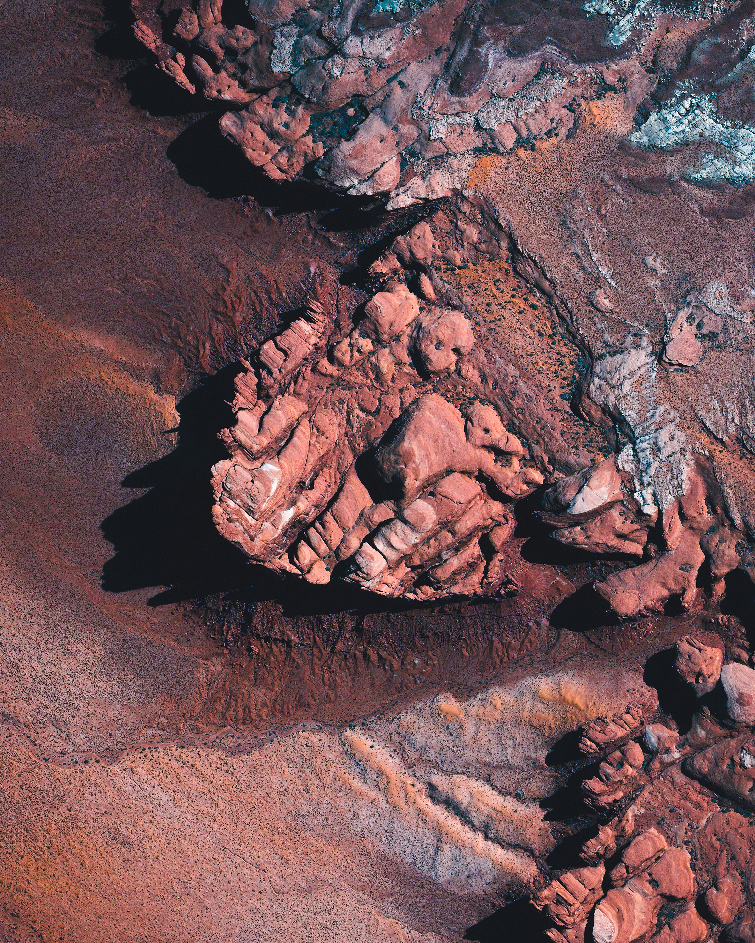 In this Overview, large rock formations are shown rising above the desert landscape in Northeastern Arizona, USA. This region is arid, largely void of greenery, and characterized by hills, mesas, buttes, cliffs and canyons. This particular outcrop is about 12.5 miles (20 km) due east of the Navajo National Monument, which contains the well-preserved cliff dwellings of the Ancestral Puebloan People. 36°53'37.6"N, 109°57'57.0"W Source imagery: DigitalGlobe