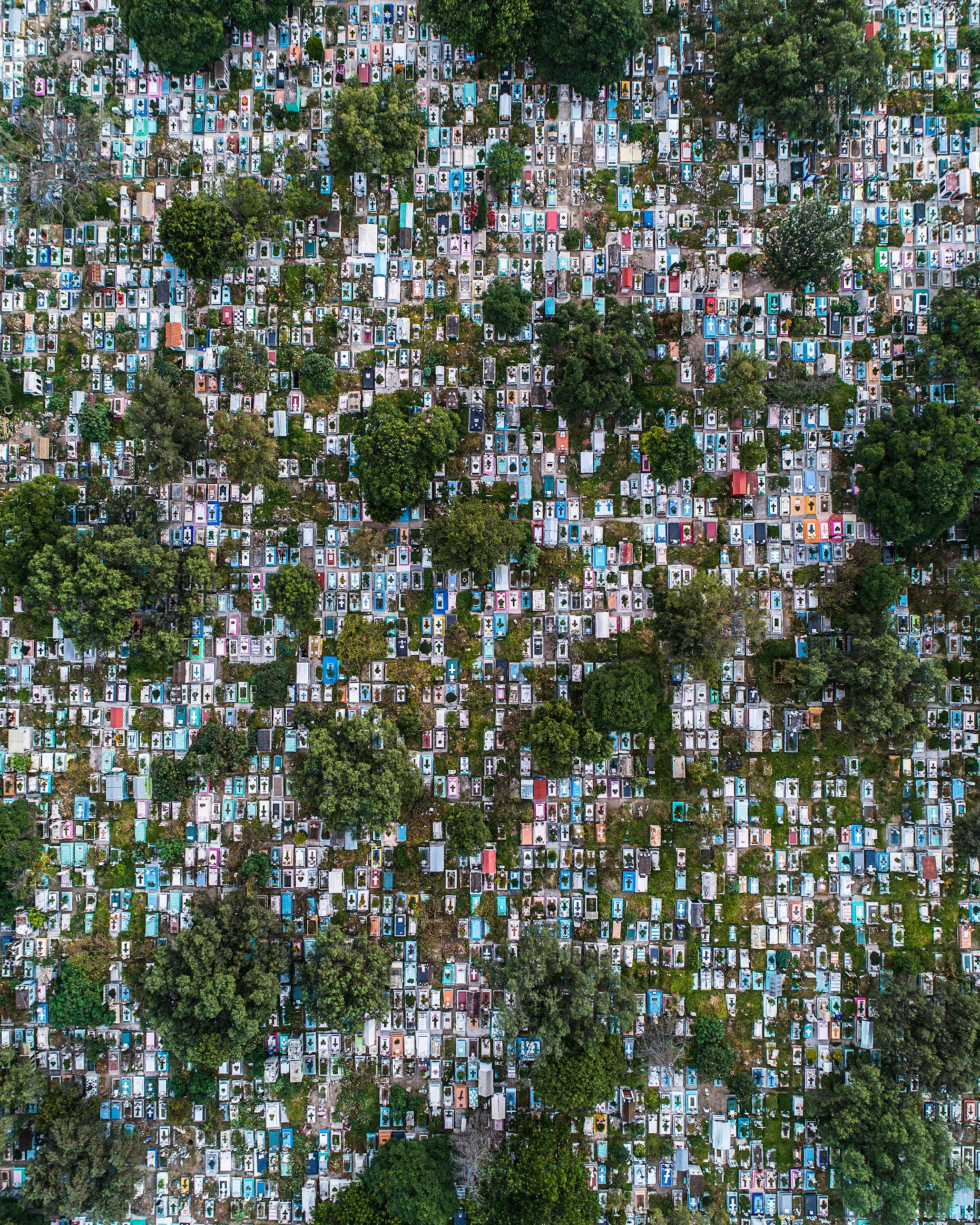 Panteón Civil San Nicolás Tolentino is a cemetery covering about 230 acres (93 hectares) in Mexico City, Mexico. Its namesake, Nicholas of Tolentino, was an Italian saint and mystic and is known as the Patron of Holy Souls. The colorful gravestones seen here are typical of cemeteries throughout Mexico, as they are meant to be an expression of culture and often reflect the deceased’s hobbies, lifestyle or profession. 19°20'21.3"N, 99°05'12.7"W Source imagery: Roberto H. (@dronerobert)