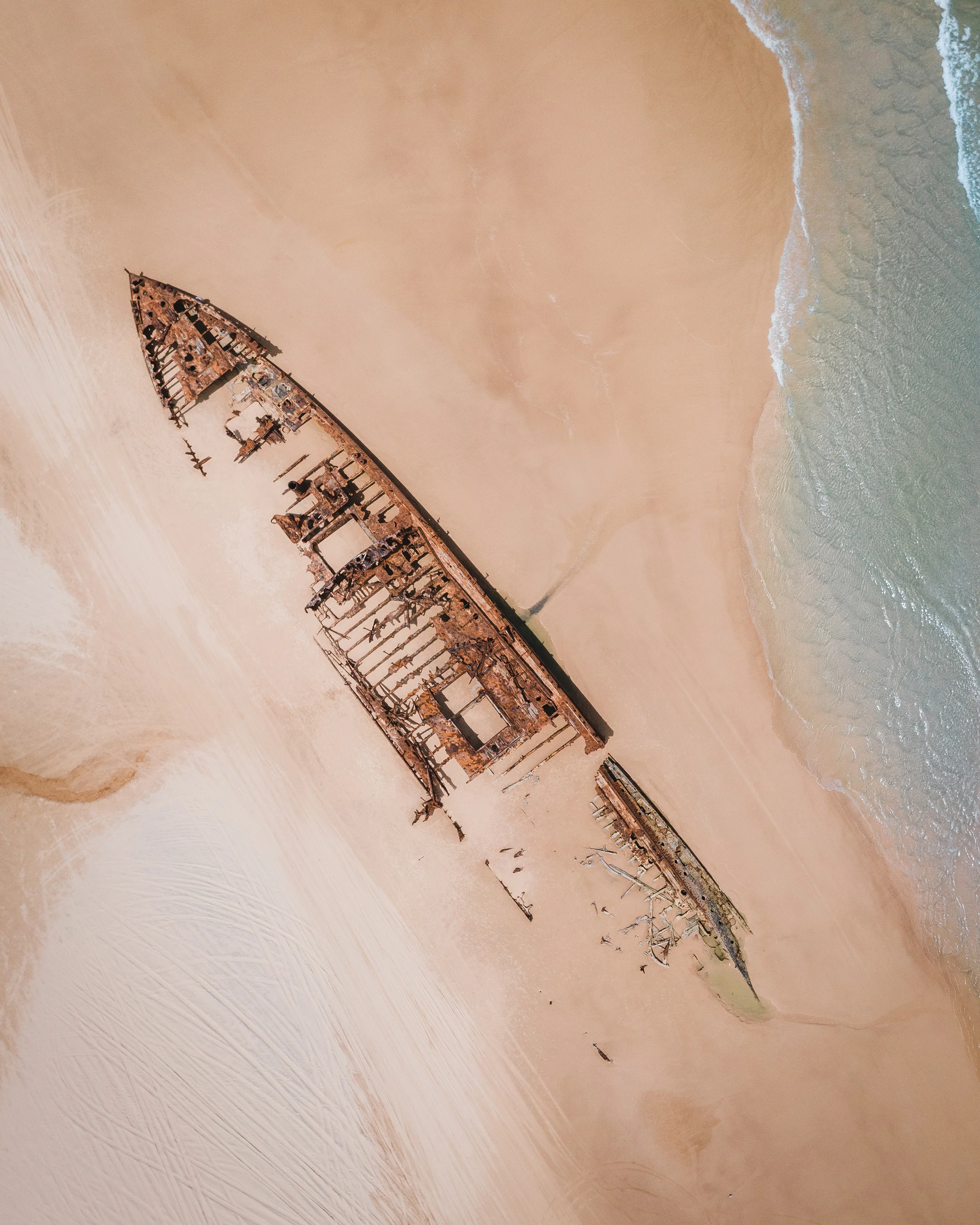 The wreck of the SS Maheno can be found on the east coast of Fraser Island in Queensland, Australia. The ship — which was washed ashore by a cyclone in 1935 — was an ocean liner that made regular crossings between New Zealand and Australia in the early 20th century. The 5,000-ton steel-hulled ship has slowly disintegrated over the years and remains a popular tourist attraction. 25°16'01.6"S, 153°14'18.8"E Source imagery: Andreas Dress (@andreasdress)