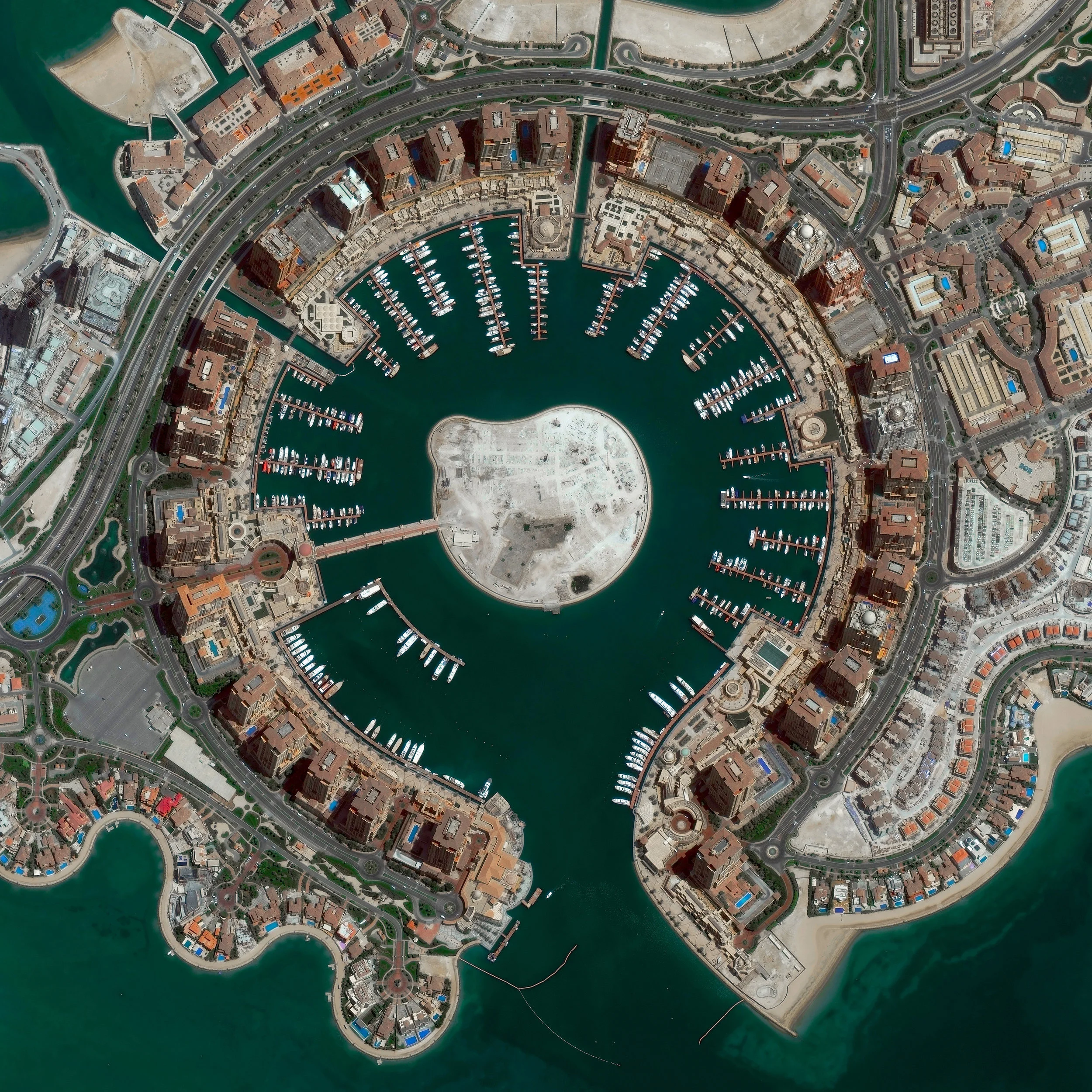 The Pearl-Qatar is an artificial island in Doha, Qatar, spanning nearly 2.5 miles (4 km) in the Persian Gulf. Once completed, the island is expected to have nearly 19,000 dwellings and 45,000 residents. Twelve precincts make up the Pearl-Qatar, and each one has a national or international theme — including aspects of Arabic, Mediterranean and European culture. 25°22'07.0"N, 51°33'07.0"E Source imagery: DigitalGlobe