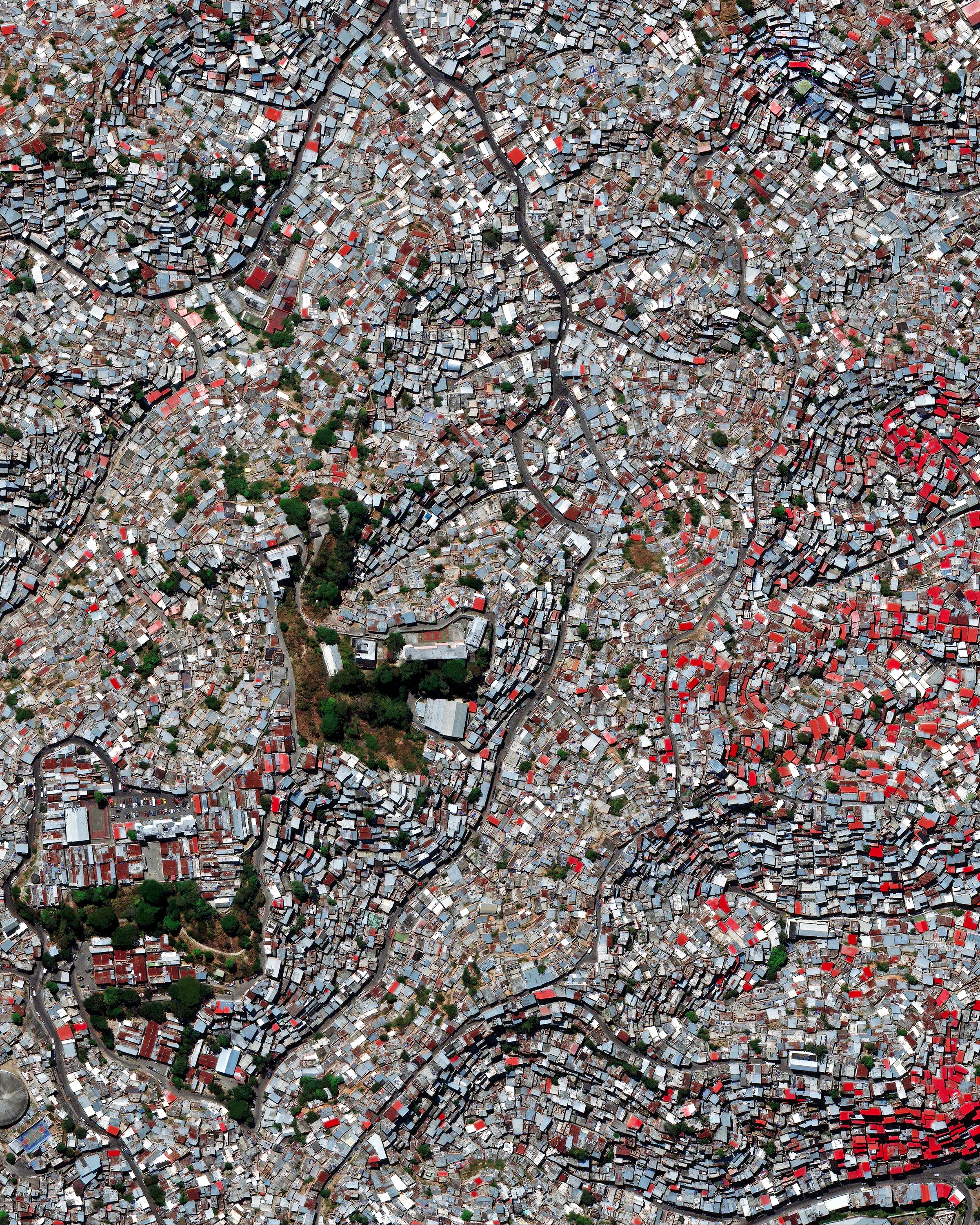 Petare is a city in northern Venezuela, and is part of the greater Caracas urban area. With a population of nearly 370,000, it is considered one of the largest slums in the world. Homes in Petare are packed tightly together and many are stacked on top of each other along landslide-prone hills. 10°29'01.9"N, 66°48'10.9"W Source imagery: DigitalGlobe