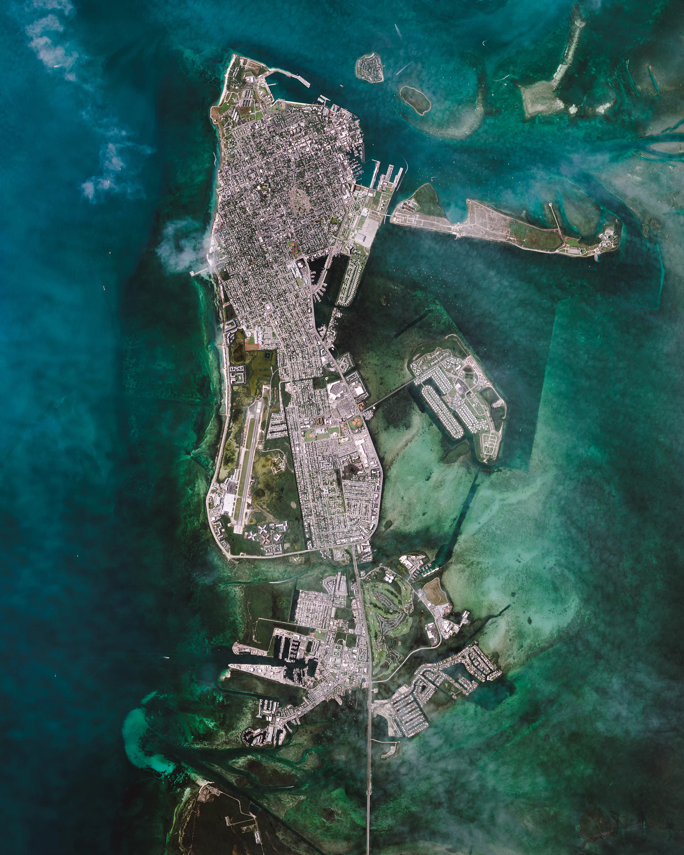 Key West is an island and city in the Straits of Florida, USA. It is the southernmost city in the contiguous United States and the westernmost island connected by highway in the Florida Keys. The island, which is about 4 miles (6.4 km) long and 1 mile (1.6 km) wide, has a population of approximately 25,000 and was visited by 2.25 million tourists in 2016. 24°33'35.0"N, 81°47'01.0"W Source imagery: Nearmap