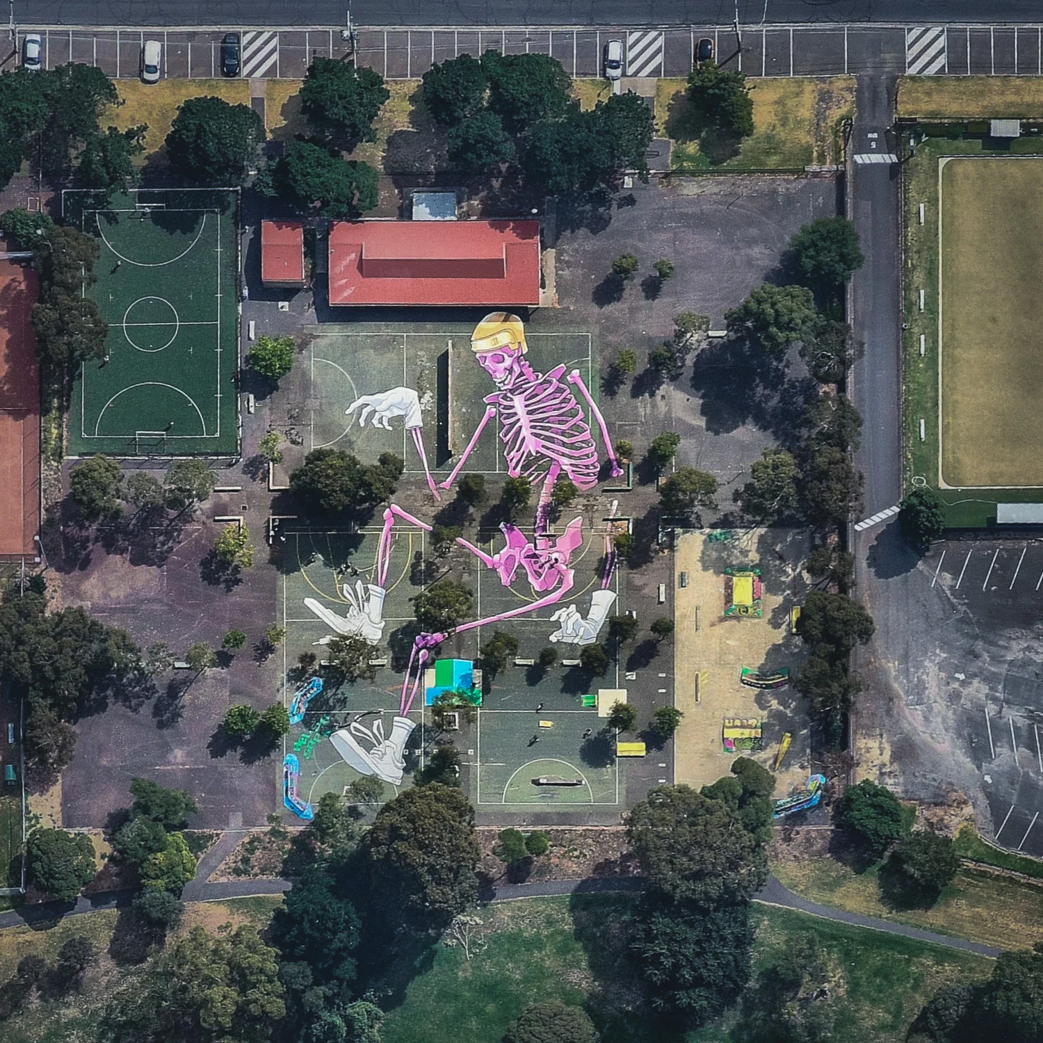 A mural of a pink skeleton covers the grounds at Reservoir Skatepark in northern Melbourne, Australia. This piece spans roughly 20,000 square feet (1,858 sq. m) and is one of many large murals in the area created by local artist Kitt Bennett. For a sense of scale, 20,000 square feet is nearly half the size of an American football field. 37°42'42.6"S, 144°59'33.1"E Source imagery: Nearmap