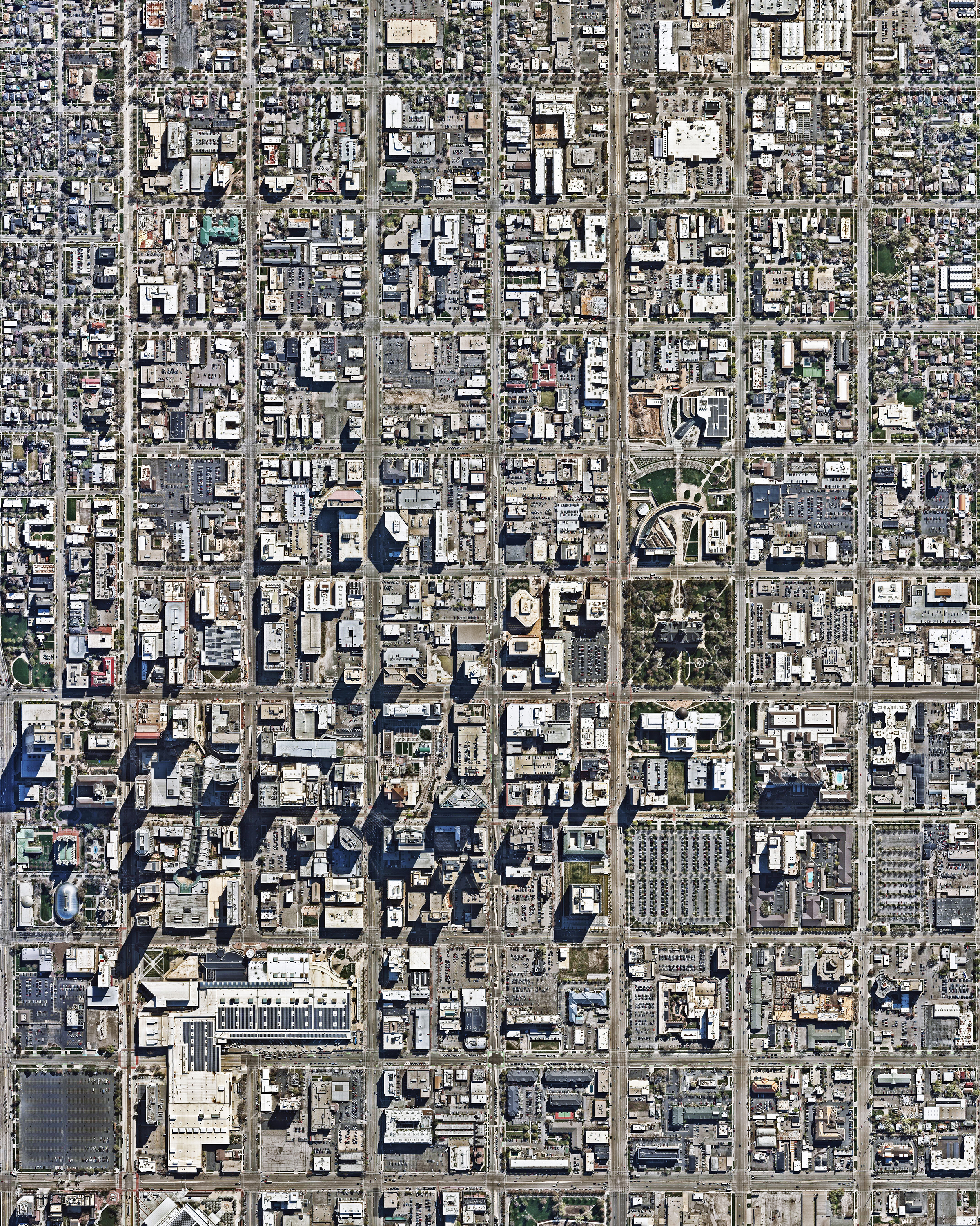 Salt Lake City is the capital and most populous municipality in the state of Utah, with about 1.2 million residents in its metropolitan area. It was founded in 1847 by followers of the Church of Jesus Christ of Latter-day Saints, who sought to escape persecution they experienced living in the east. As shown in this Overview, the city has a distinct north-south east-west grid system, which was laid out by church leader Brigham Young using what was called the "Plat of Zion" or the "Mormon Grid." 40°45'50.0"N 111°53'21.7"W Source imagery: Nearmap