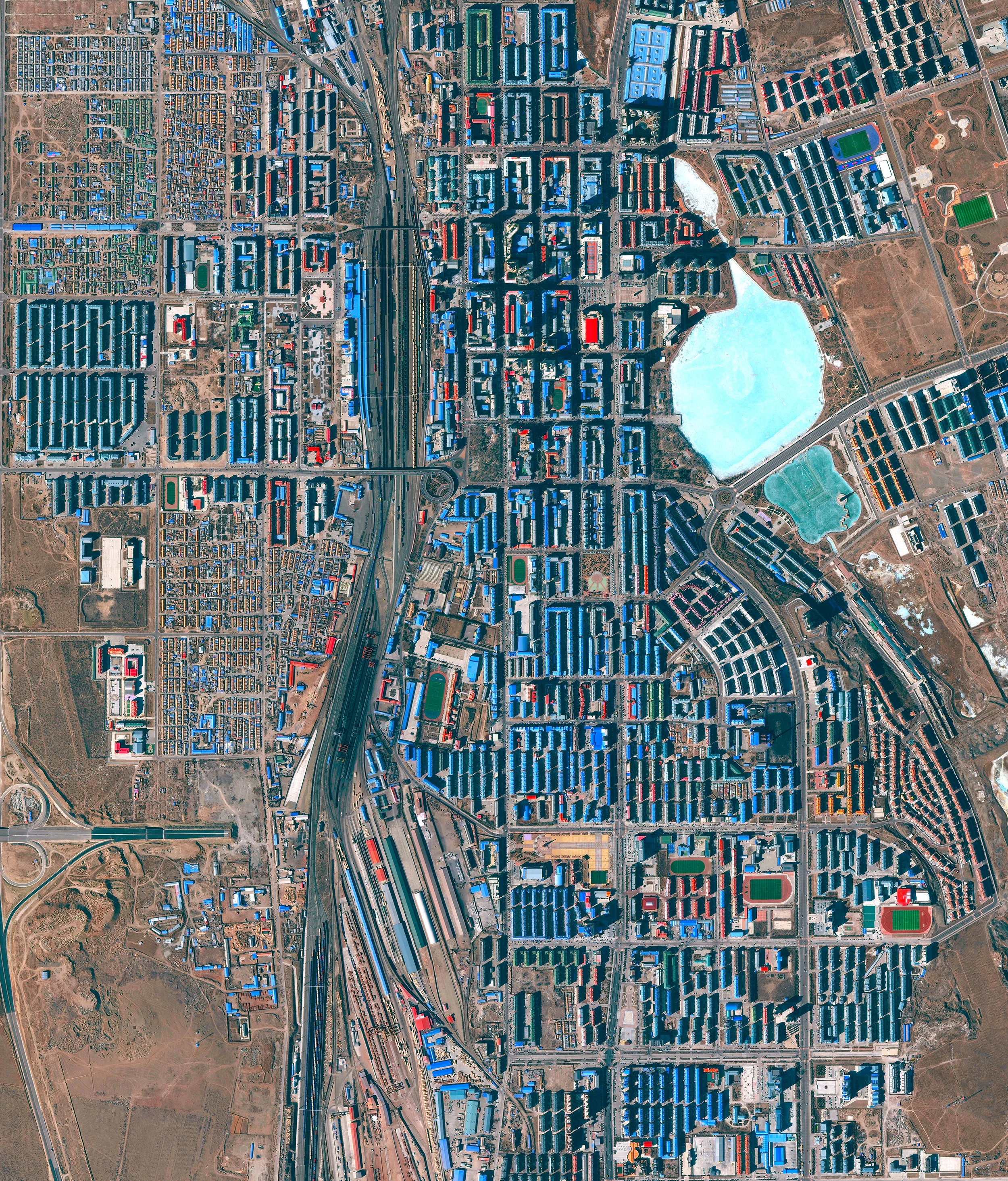 Manzhouli is a sub-prefectural city in the Inner Mongolia Autonomous Region of China. Located on the border with Russia, it is a major land port of entry and has experienced a boom in recent years as a center of Sino-Russian trade. Since China restricted commercial logging two decades ago, hundreds of factories have opened in Manzhouli to take advantage of lumber from Russia — demand for which is depleting many of Russia's forests. 49°35'52.8"N 117°22'44.4"E Source imagery: Maxar Technologies