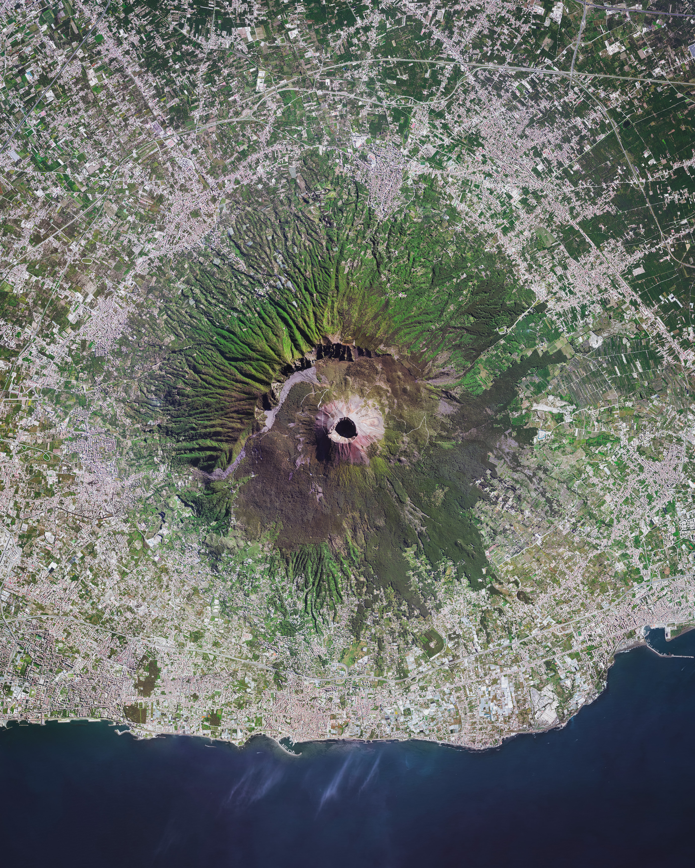 Mount Vesuvius is a somma-stratovolcano located in Campania, Italy, about 5.6 miles (9 km) east of Naples. It is best known for its eruption in AD 79, which killed thousands and destroyed the Roman cities of Pompeii, Herculaneum, Oplontis and Stabiae. With an eruption as recent as 1944 and at least 3 million living nearby, Vesuvius is regarded as one of the most dangerous volcanoes in the world. 40°49'00.0"N 14°26'00.0"E Source imagery: Maxar Technologies