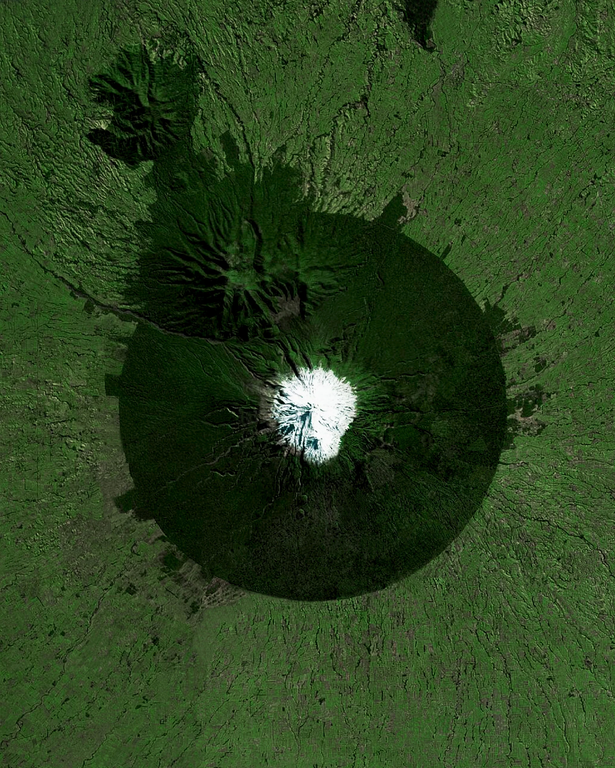 Mount Taranaki, also known as Mount Egmont, is an active stratovolcano on the west coast of New Zealand’s North Island. A change in vegetation is sharply delineated between the protected national forest that encircles the volcano and the surrounding land comprised of intensively-farmed dairy pastures. -39.297166, 174.063228 Source imagery: Maxar Technologies