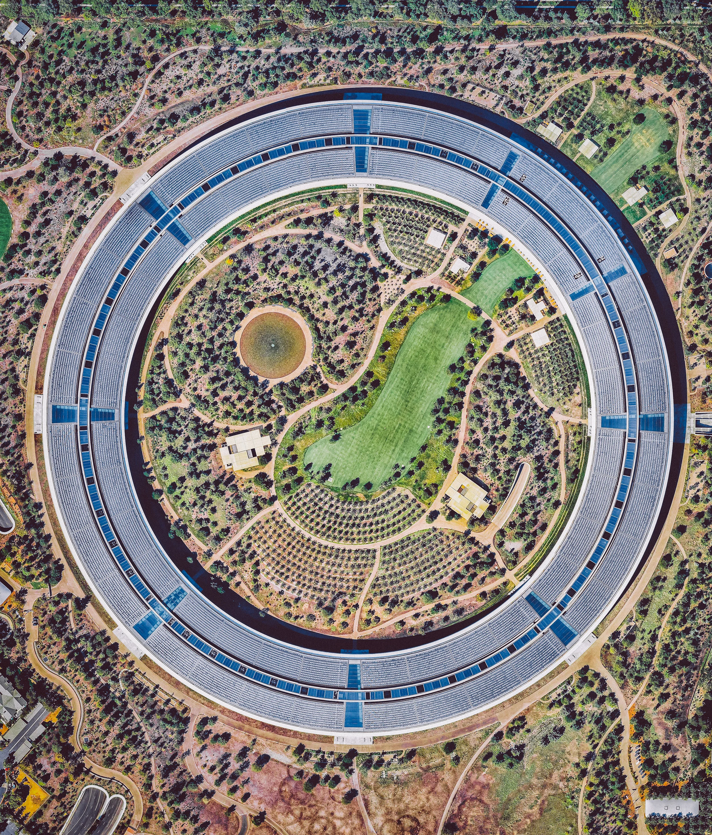 Apple Park is the corporate headquarters of Apple Inc., located in Cupertino, California, USA. It was opened to employees in April 2017, superseding the original "Apple Campus," which opened in 1993. Currently, more than 12,000 employees work in the four-story office building, which has a circumference of 1 mile (1.6 km) and a floor area of 2.8 million square feet (260,000 square meters). 37.334185°, -122.009930° Source imagery: Nearmap