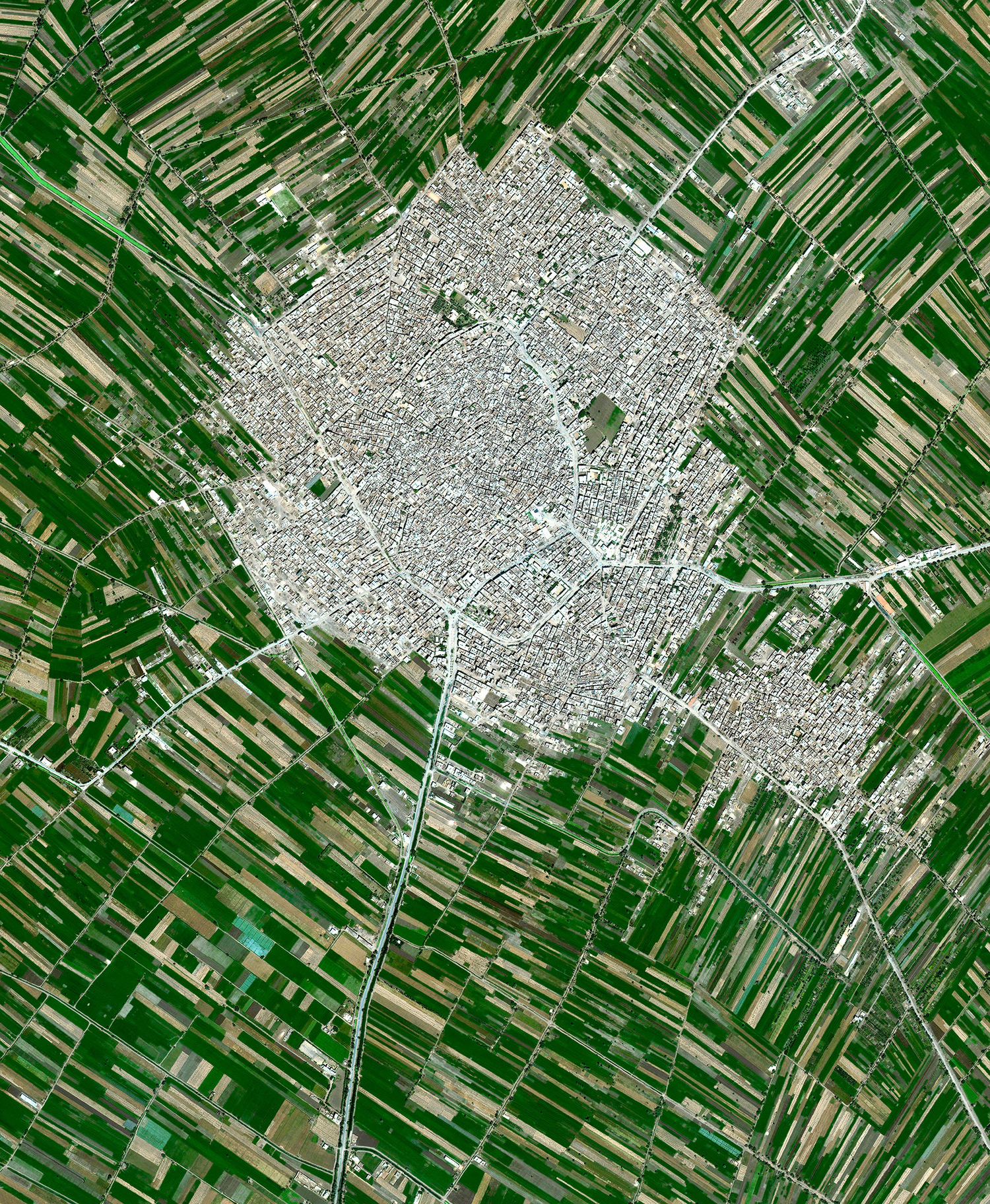 Agricultural development encircles the towns of Ausim and Shinbari in the Cairo Governorate of Egypt. The towns are located within the fertile area surrounding the Nile River, the country’s main source of water because it has no effective rainfall. The roughly 55 billion cubic meters of water that are used from the river each year represents more than three quarters of the country’s resources for usable water. 30.1229437°, 31.1336762° Source imagery: Maxar Technologies
