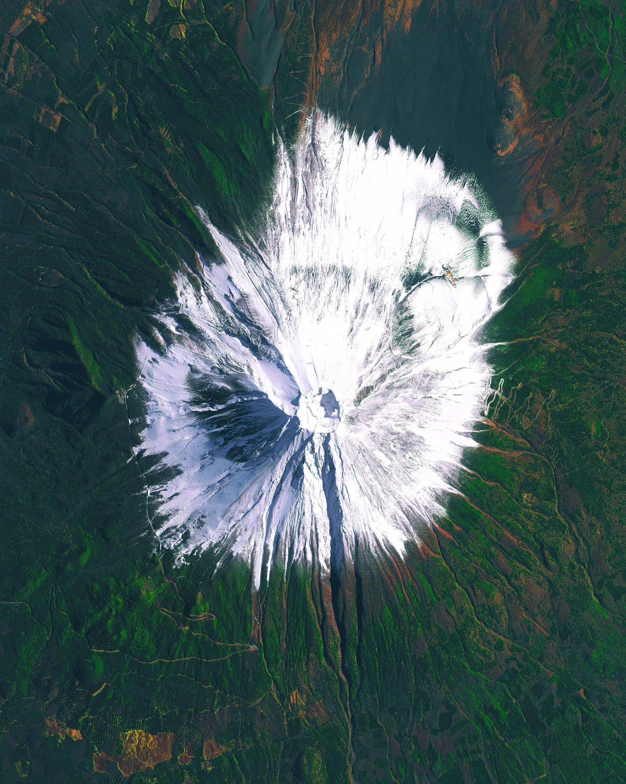 Mount Fuji is an active stratovolcano and the tallest peak in Japan, with an elevation of 12,389 feet (3,776 meters). Fuji has an extremely symmetrical cone, which is snow‑capped for much of the year. During warmer months, climbing routes make it possible for hundreds of thousands of people to scale the volcano. 35.358056°, 138.731111° Source imagery: Maxar Technologies