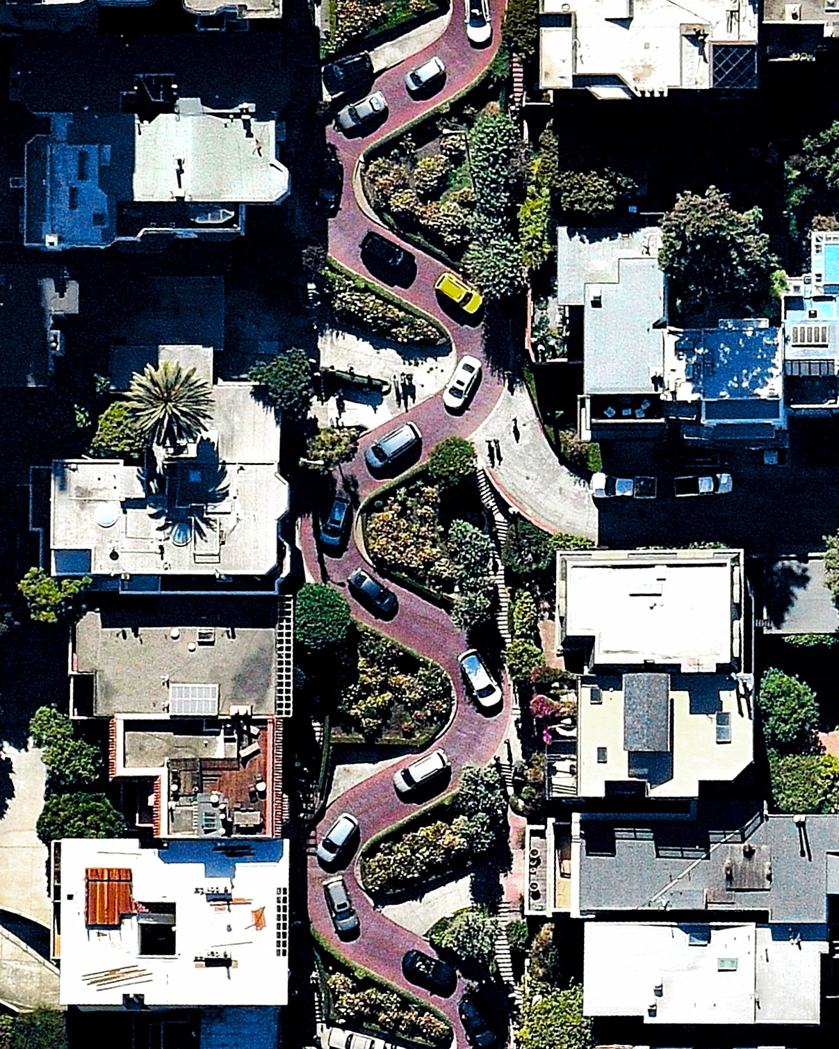 Cars wind down the hill of Lombard Street, which runs from east to west in San Francisco, California, USA. With eight hairpin turns dispersed over a one-block section in the Russian Hill neighborhood, Lombard is often referred to as “the most crooked street in the world." 37.802193°, -122.418598° Source imagery: Nearmap