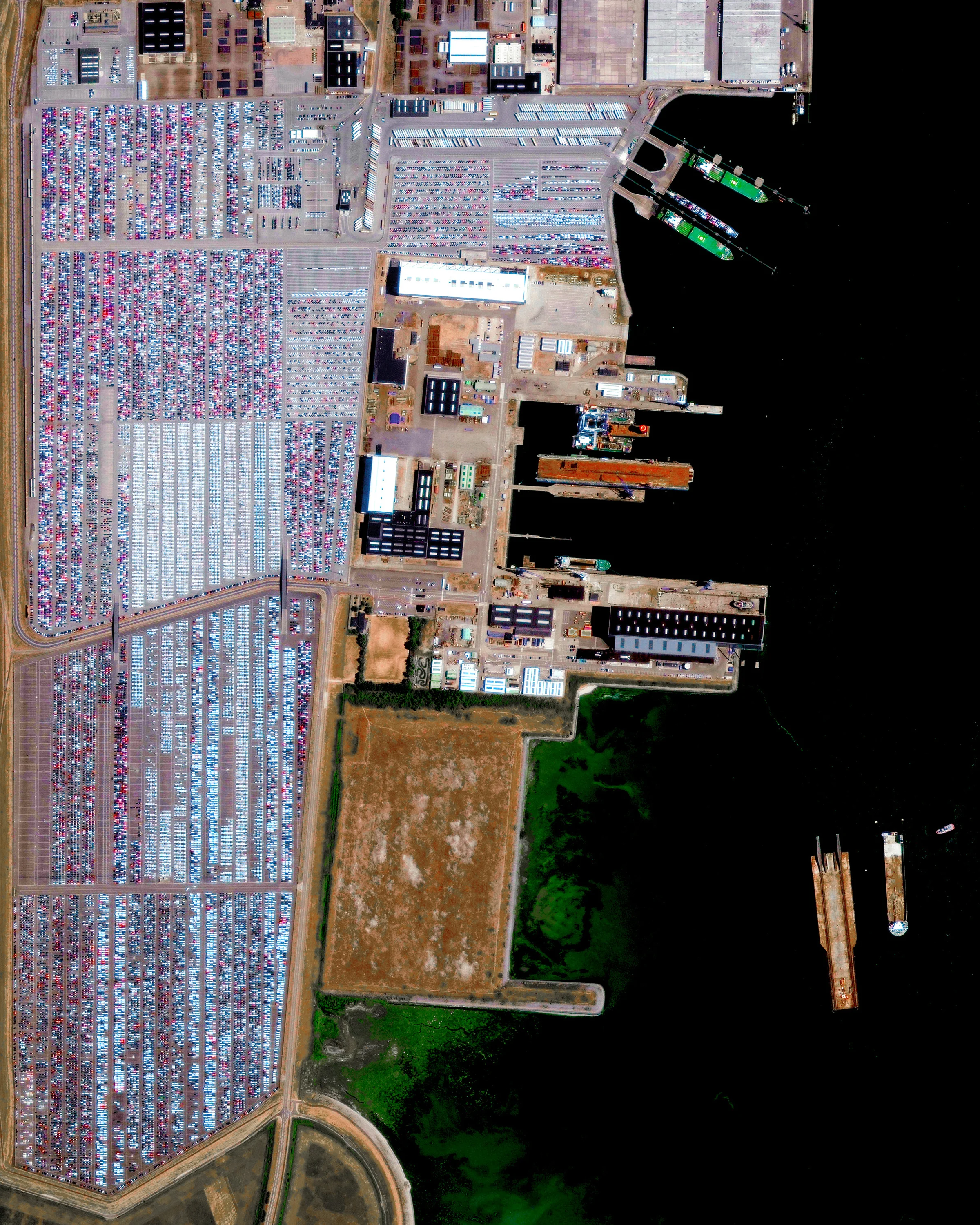 Thousands of vehicles are parked at the port of Vlissingen-Oost, located on the Westershelde estuary in southwestern Netherlands. This facility covers approximately 5,436 acres (2,200 hectares) and is a hub for "Roll-on/Roll-off" cargo — cars, vans, trucks, trailers and other vehicles. Other services performed at Vlissingen-Oost include oil refining, storage and transfer of fruit, metal, wood, ores and energy generation. 51.467239°, 3.674688° Source imagery: Maxar Technologies