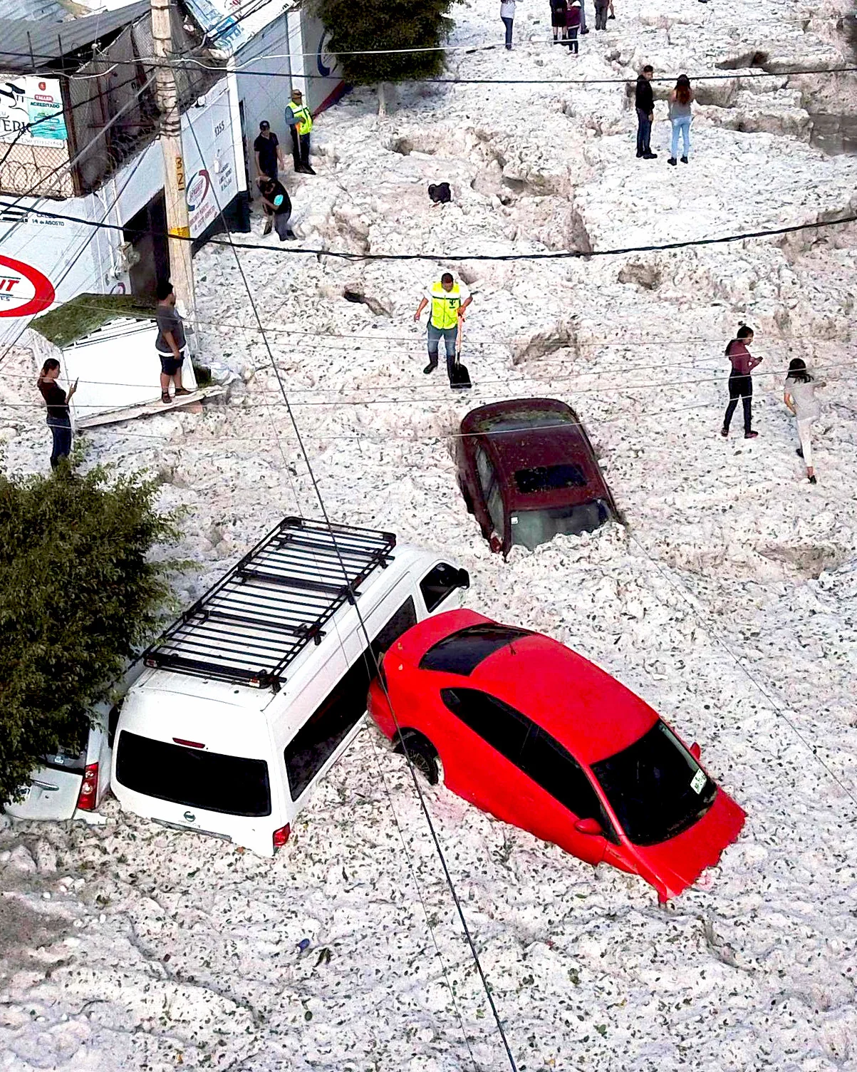 Several neighborhoods of Guadalajara, Mexico, are currently buried in feet of ice after an unusual summer hailstorm hit the city on Sunday. Upwards of 200 buildings were damaged and 50 vehicles were buried by the ice, which can be seen in this photo blanketing an entire street. Hailstorms are not uncommon during the summer in Guadalajara, but media reports claim no storm of this magnitude has ever been recorded. 20.676667°, -103.347500° Source imagery: Ulises Ruiz, AFP/Getty Images
