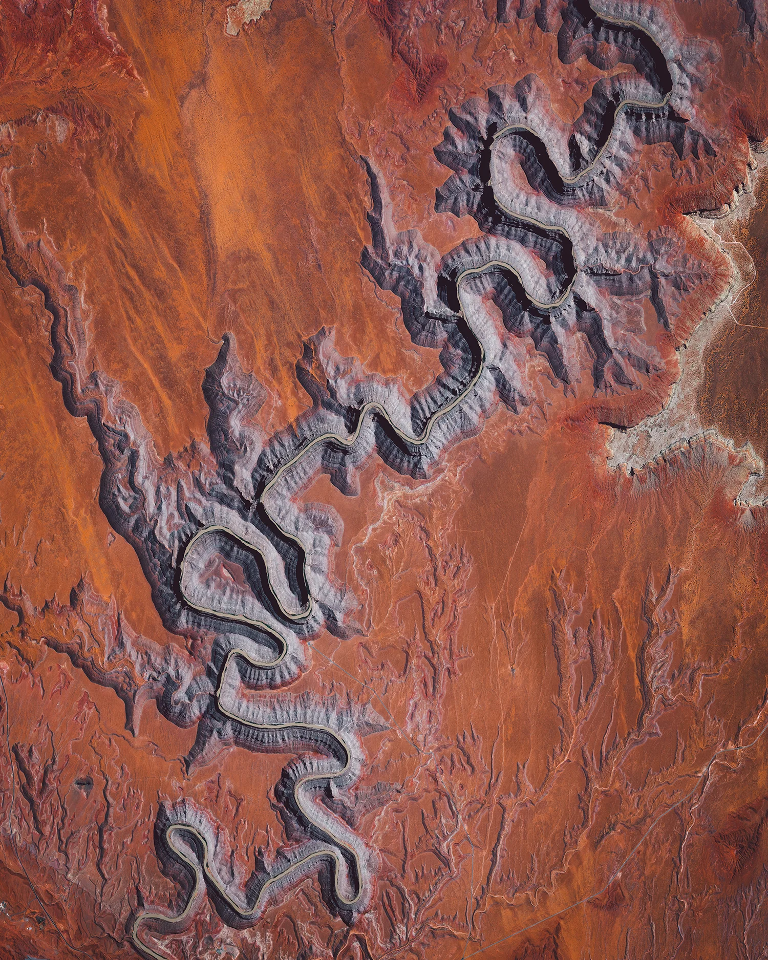 In this Overview, the San Juan River is shown meandering through southeastern Utah, not far from Goosenecks State Park. It is a major tributary of the Colorado River and provides drainage to the Four Corners region of Colorado, New Mexico, Utah and Arizona. The San Juan is one of the muddiest rivers in North America, carrying an average of 25 million U.S. tons of silt and sediment each year. 37.206203°, -109.995573° Source imagery: Maxar Technologies