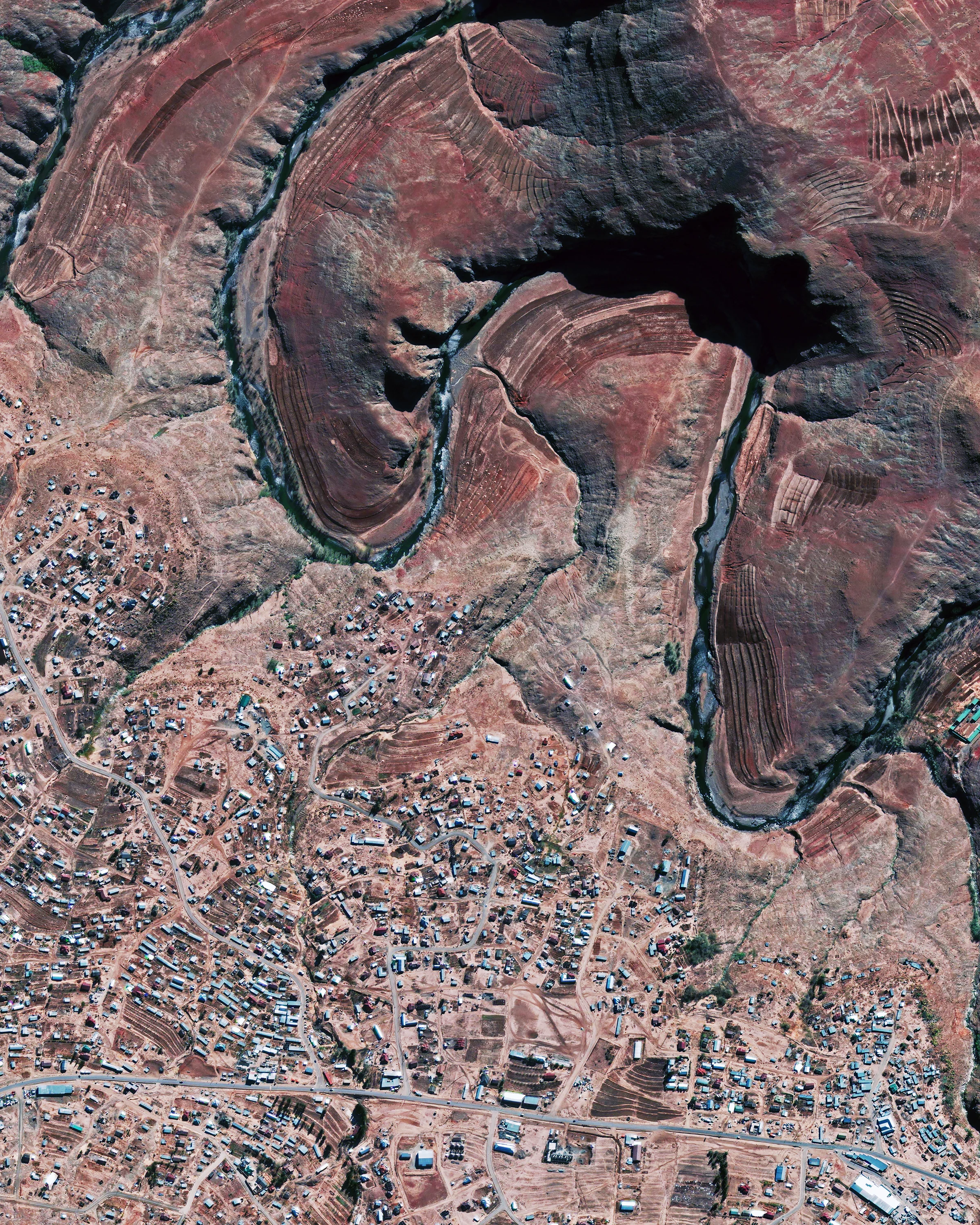Mokhotlong is a city in the mountainous northeastern part of Lesotho, Africa. It has an average elevation around 8,200 feet (2,500 m) and contains the highest point in southern Africa — Thabana Ntlenyana, an 11,424-foot (3,482 m) peak. Mokhotlong’s economy is primarily driven by livestock rearing and subsistence agriculture, though neither of these fully support its largely impoverished population of about 8,800 people. -29.288495°, 29.065568° Source imagery: Maxar Technologies