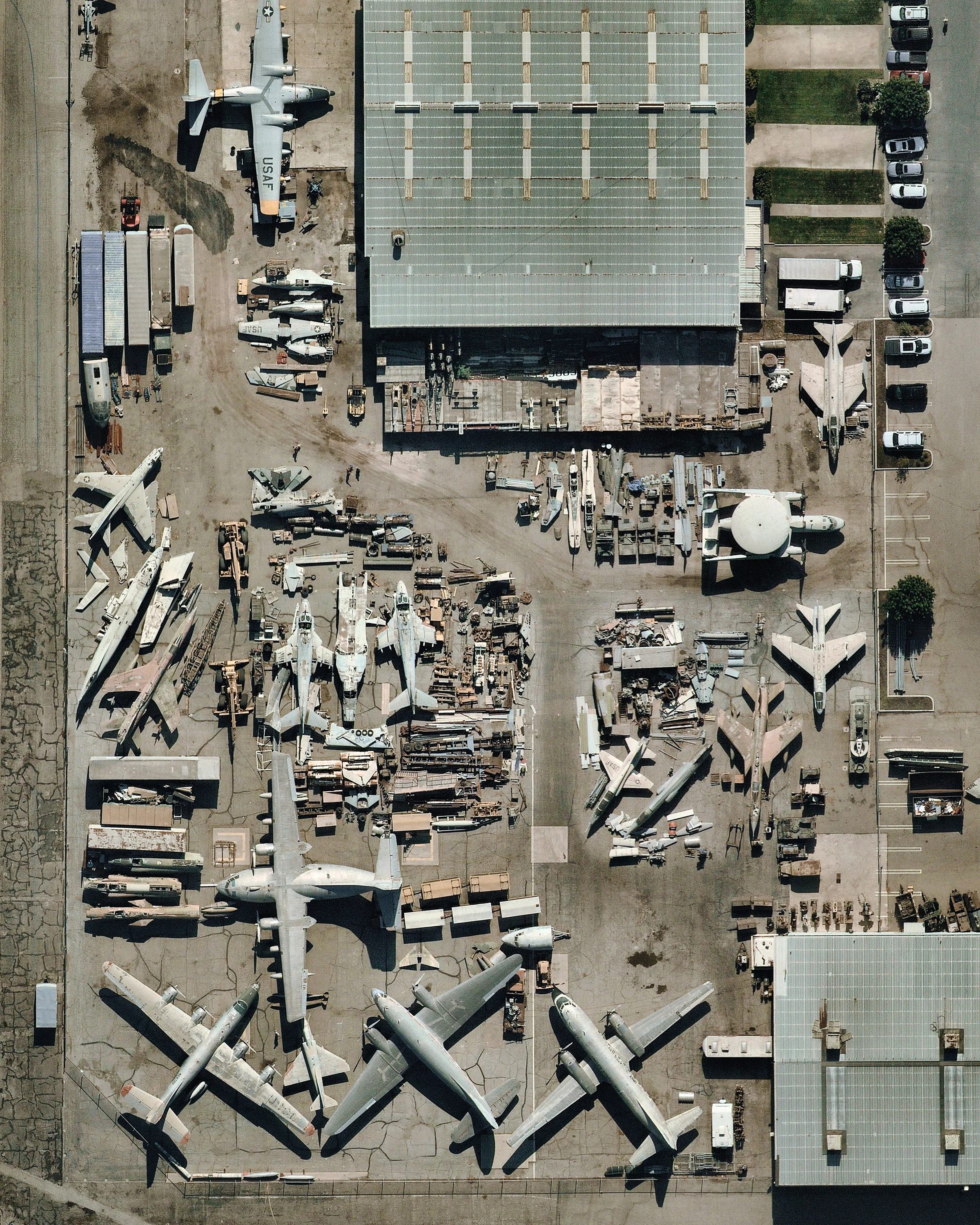 A variety of aircraft and parts sit near the Yanks Air Museum in Chino, California. Dedicated to exhibiting, preserving and restoring American aircraft and artifacts, this facility houses one of the largest and most historically significant collections of American aircraft including World War II fighters, dive and torpedo bombers. The collection exceeds 190 aircraft, with some being the last survivors of their type. 33.979574°, -117.646142° Source imagery: Nearmap