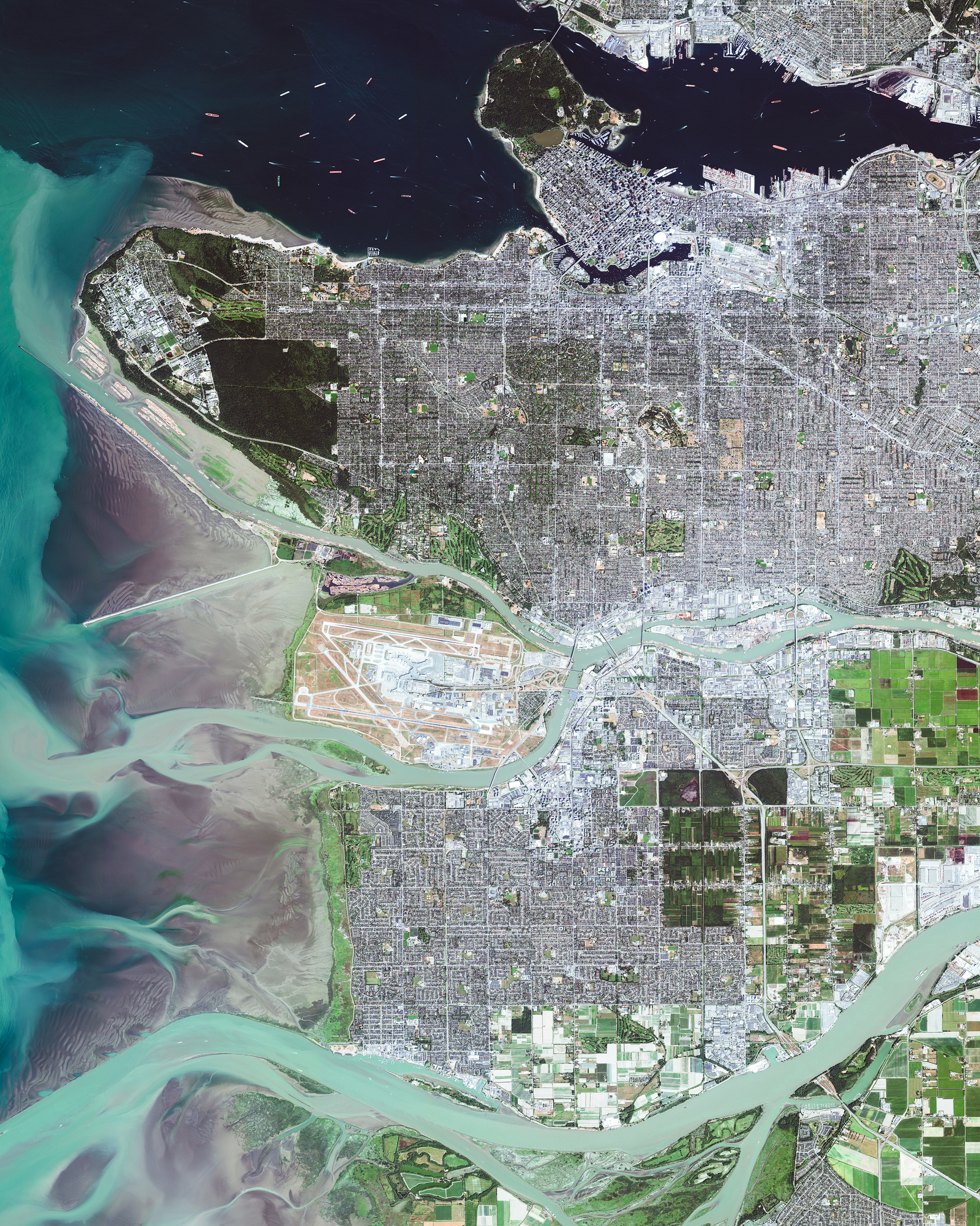 Greater Vancouver is the most populous metropolitan area in British Columbia, Canada, with roughly 2.5 million residents. Officially known as the Metro Vancouver Regional District, it comprises 21 municipalities, one electoral area and one Treaty First Nation. As seen in this Overview, the area is bisected by the Fraser River, which travels 854 miles (1,375 km) through British Columbia before emptying into the Pacific Ocean -- depositing 20 million tons of sediment per year. 49.250000°, -123.100000° Source imagery: Maxar Technologies