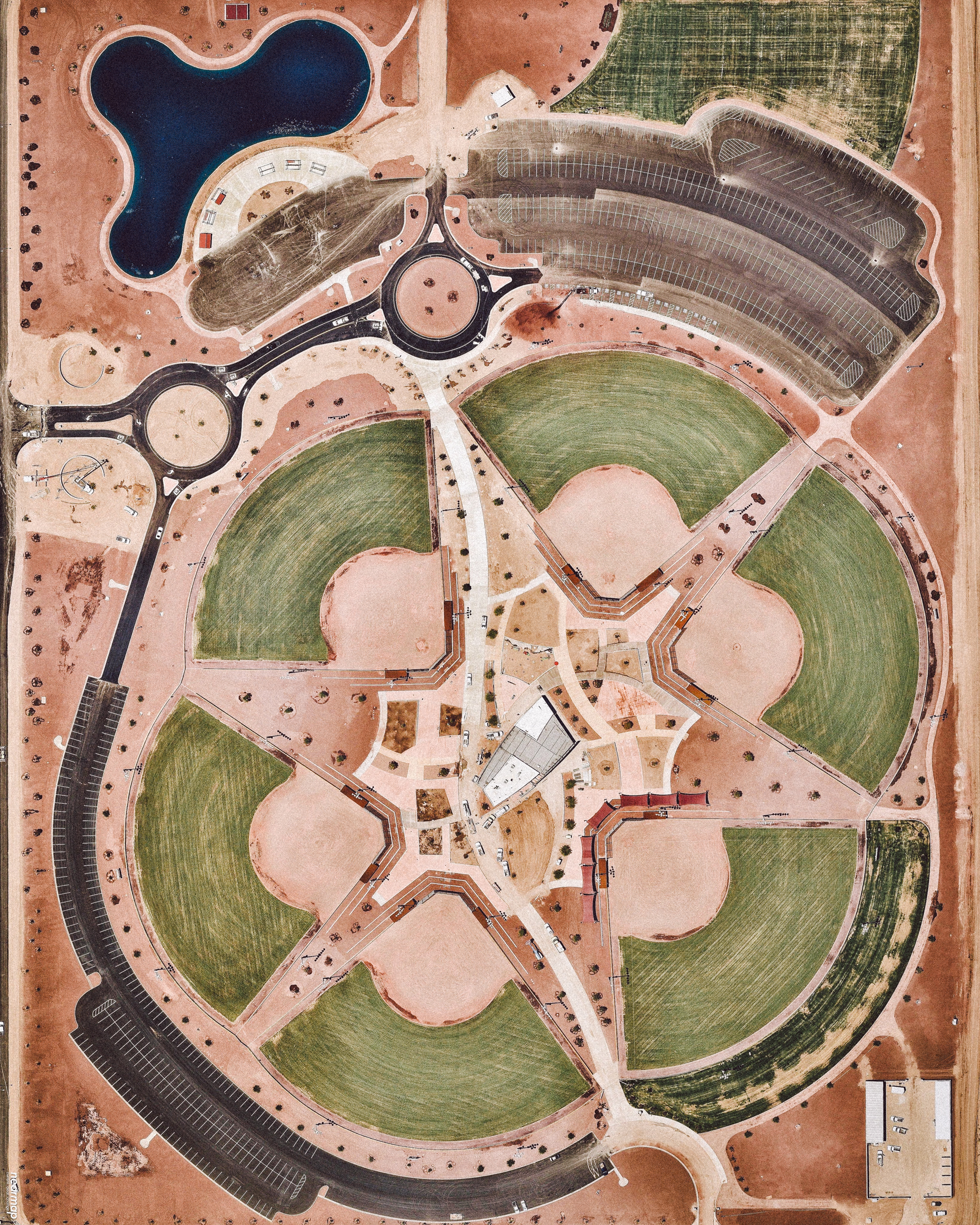 Six softball fields take shape at the Pacific Avenue Athletic Complex in Yuma, Arizona — which was still under construction when this Overview was captured last summer. Now open to the public, this 50-acre (20-hectare) facility boasts lighted softball fields, a walk and bike trail, fishing pond, playground, concessions, paved parking for at least 900 vehicles, and more. The Yuma metropolitan area is home to roughly 203,000 people. 32.715000°, -114.601806° Source imagery: Nearmap