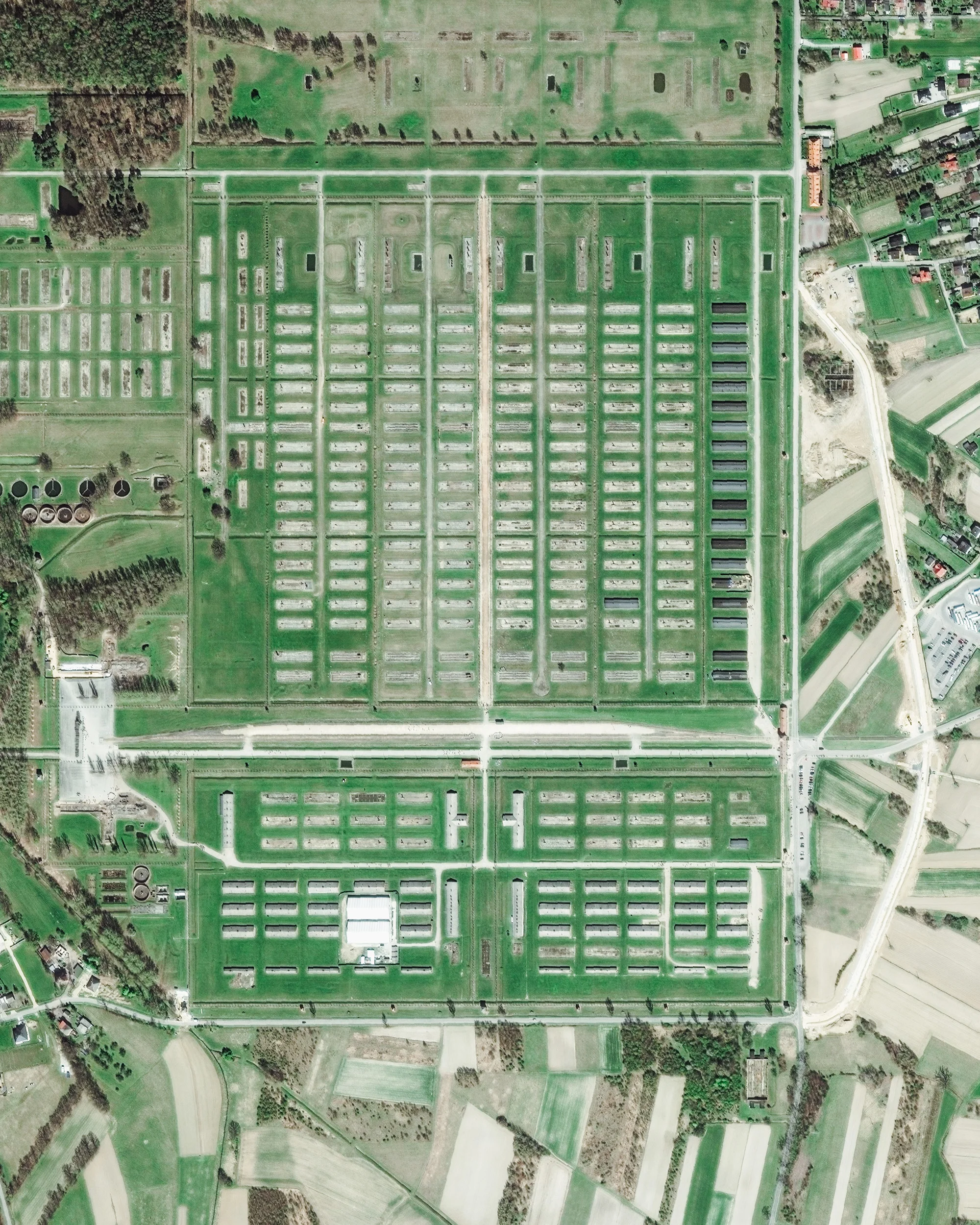 The Auschwitz-Birkenau Memorial and Museum in Oświęcim, Poland, is a series of remembrance sites that include the former German Nazi concentration camps Auschwitz I and Auschwitz II-Birkenau. It is devoted to the memory of the victims who died at both camps during World War II. This Overview shows Birkenau, which housed as many as 200,000 prisoners at once and was responsible for 90% of the deaths in the Auschwitz complex — approximately a million people. In 2017, the museum had 2.1 million visitors from across the world. 50.027611°, 19.203083° Source imagery: Maxar Technologies