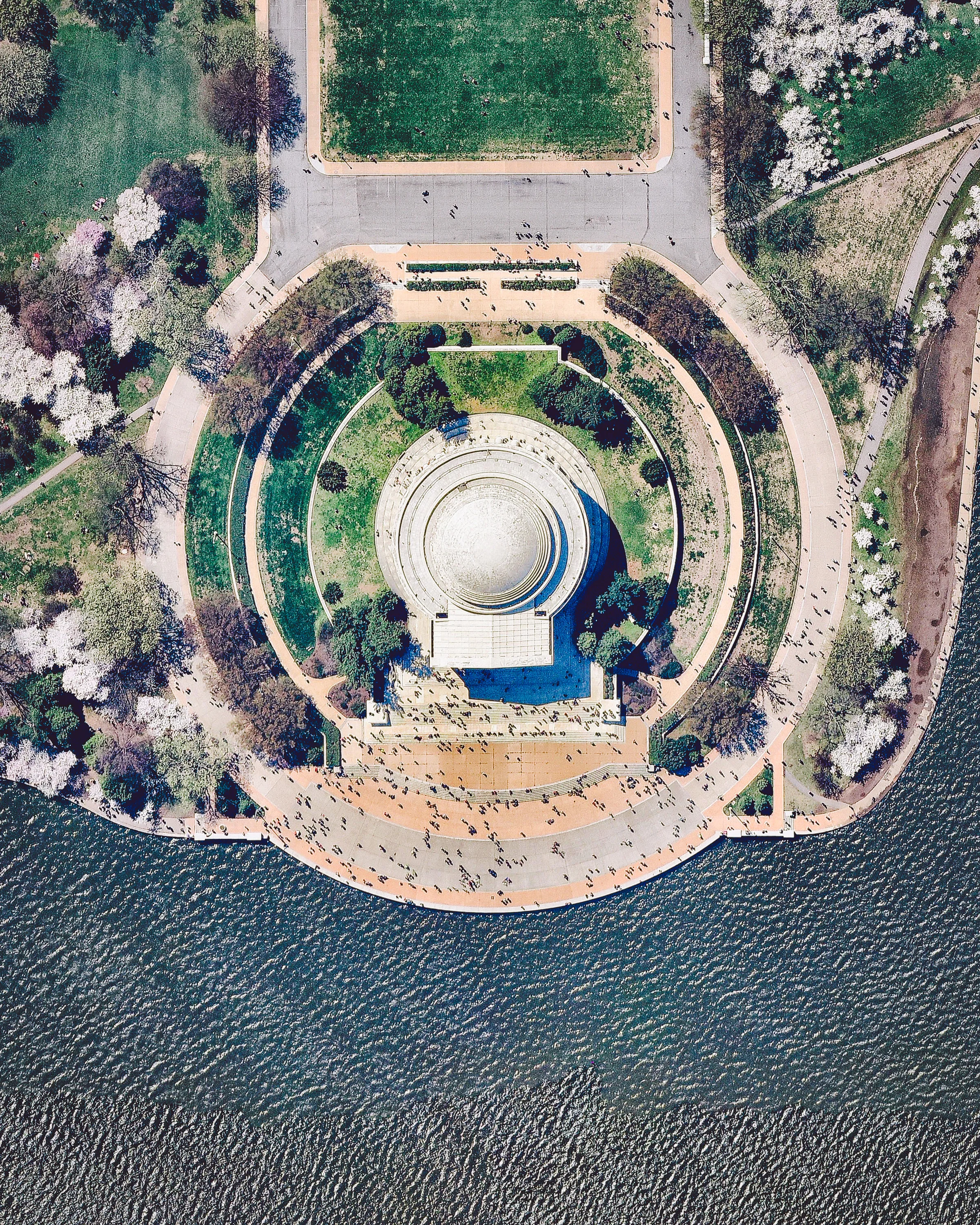 Crowds of people gather at the Jefferson Memorial in Washington, D.C. Constructed between 1939 and 1943, the memorial honors Thomas Jefferson, a Founding Father and third president of the United States. Its neoclassical, Pantheon-like structure is composed of circular marble steps, a portico, a circular colonnade of Ionic order columns, and a shallow dome. In 2018, the Jefferson Memorial had approximately 3.2 million visitors. 38.881389°, -77.036944° Source imagery: Nearmap
