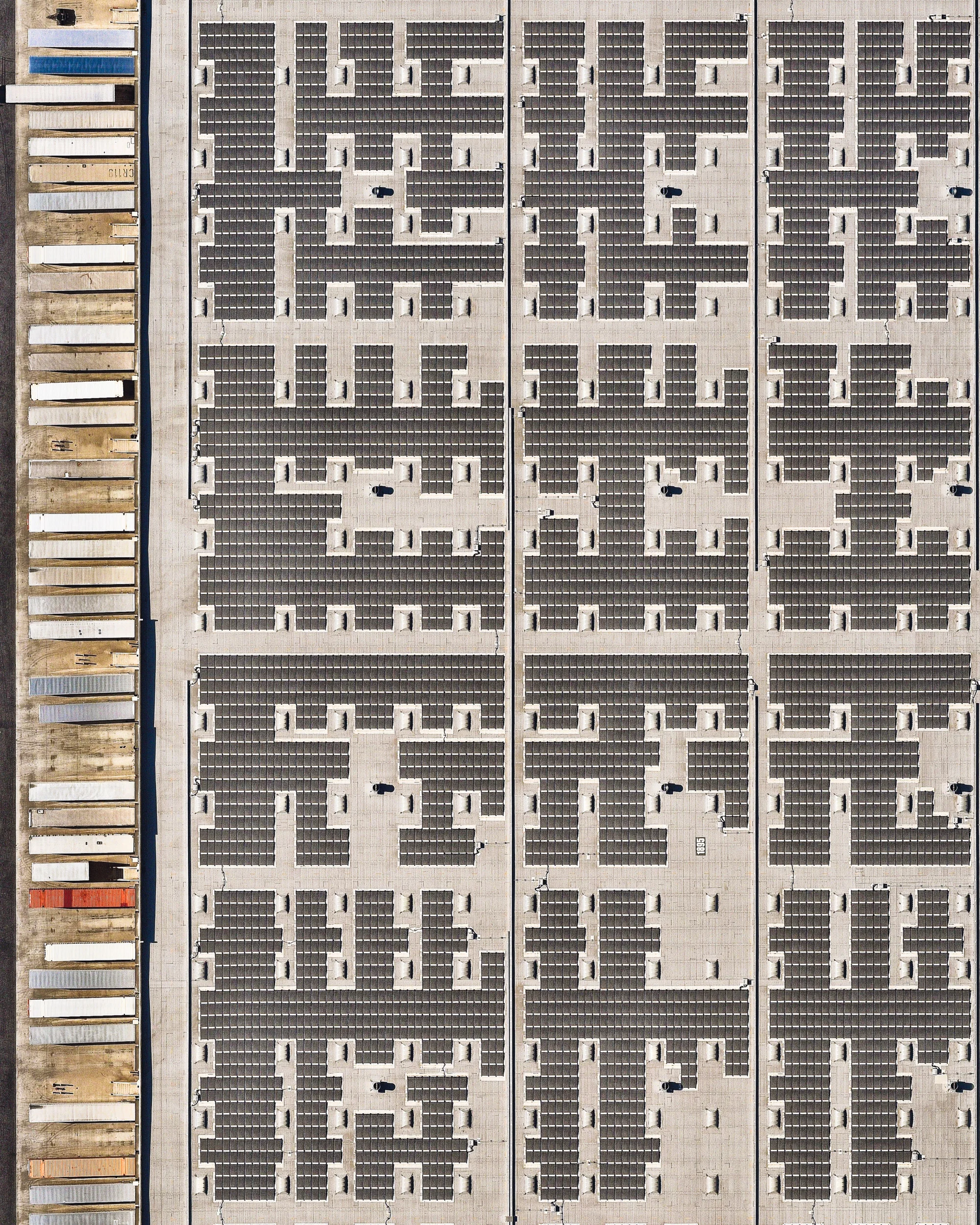 Semi-trailers line up at the loading bays of a solar-panel-covered warehouse in Redlands, California. Located in San Bernardino County, Redlands is a city of approximately 71,000 people. In the last decade, San Bernardino and Riverside counties have experienced a boom in warehouses and distribution centers, creating an estimated 84,000 jobs — nearly a quarter of the region's added employment. 34.086675°, -117.228011° Source imagery: Nearmap