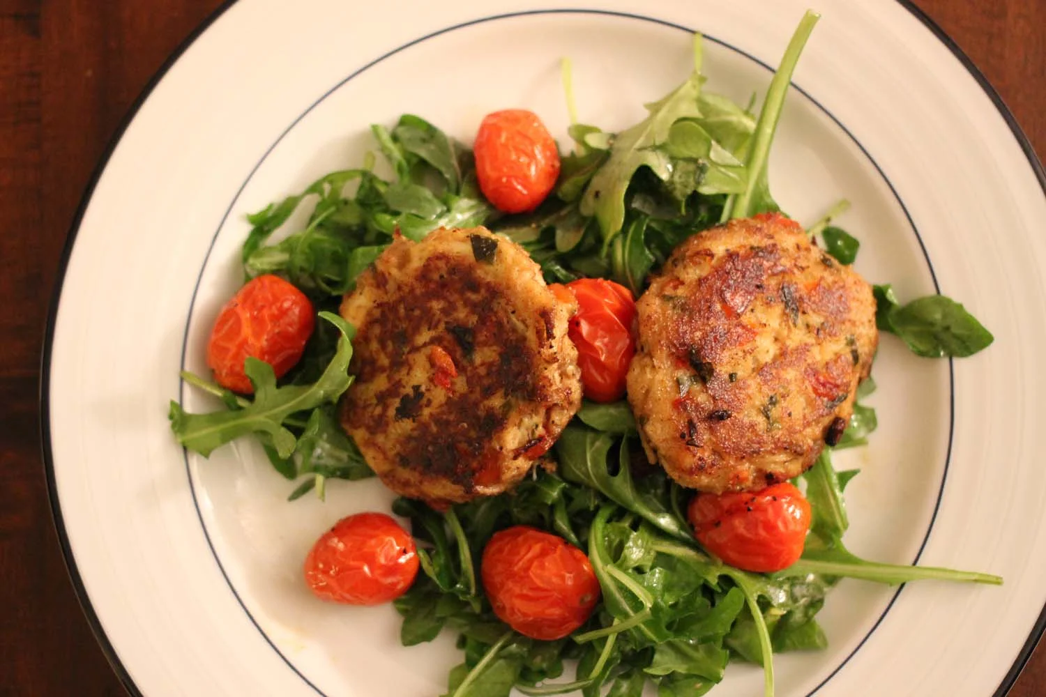 Crab Cakes and Arugula Salad with Roasted Tomatoes: Image: Laura Messersmith