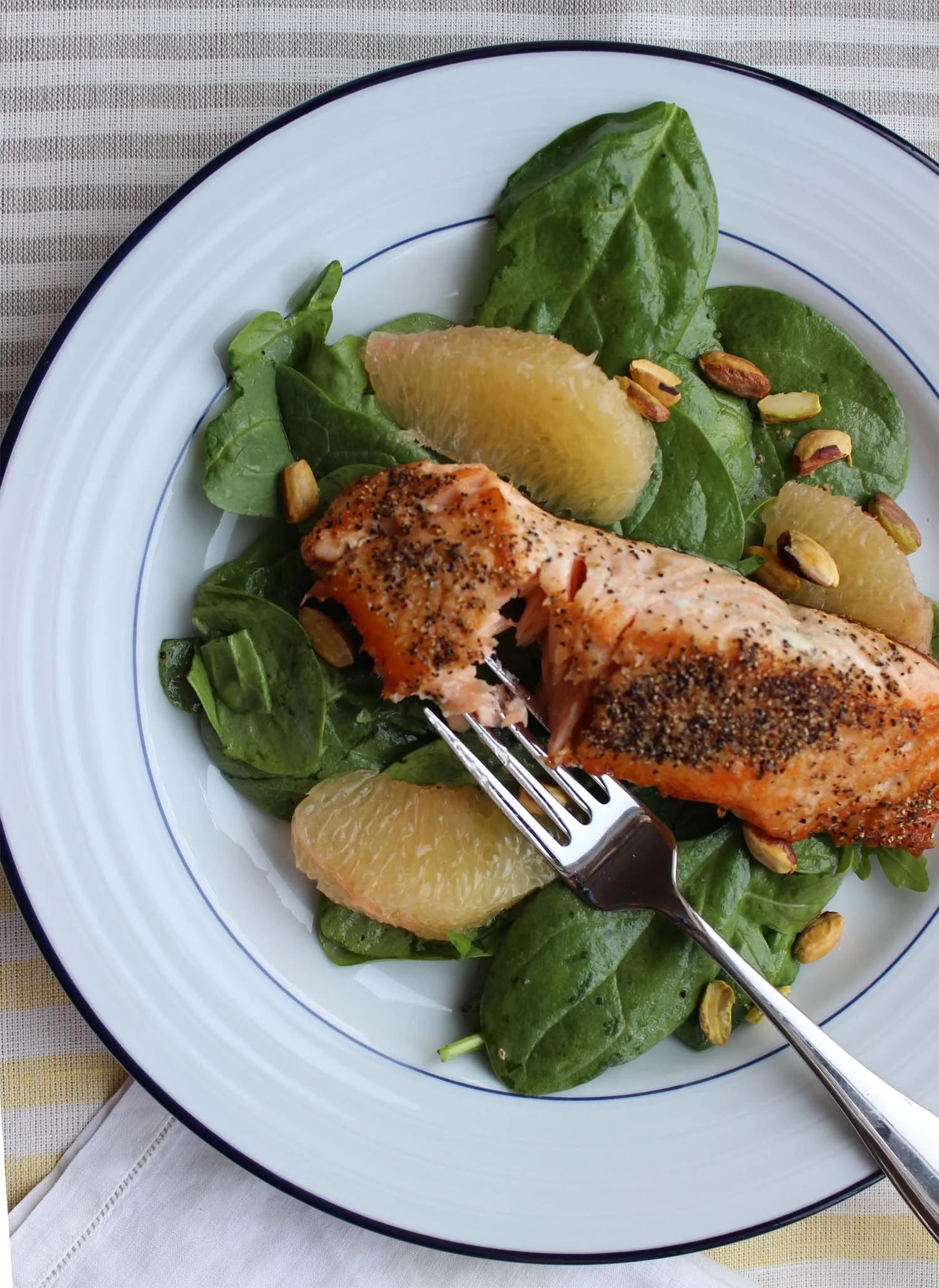 Pan-Fried Salmon with Grapefruit, Pistachio and Spinach Salad | Image: Laura Messersmith
