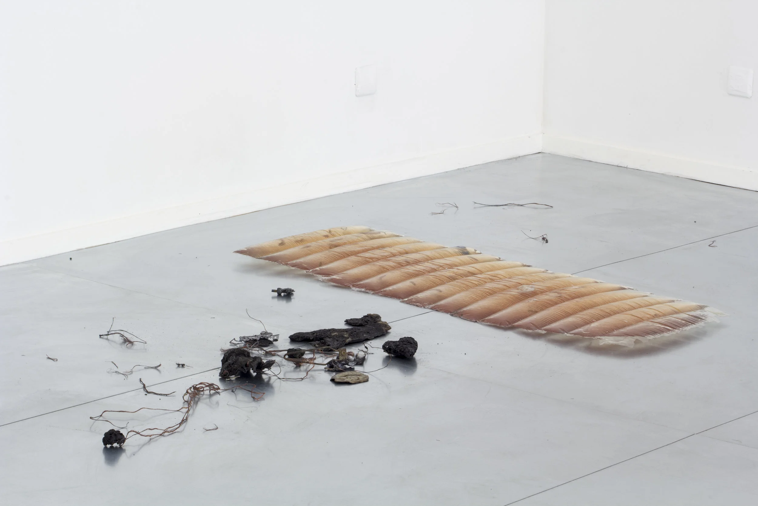 Sleepwalker , 2018 Polyester resin, found objects, burnt mechanical parts