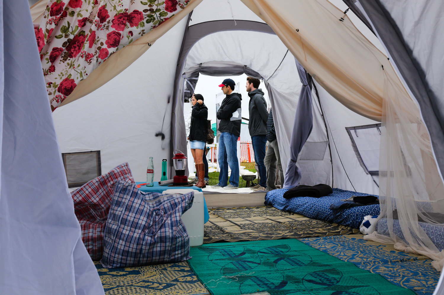 What it's like inside a two-family tent: A cloth divider to split the space in two, canvas mats, small mattresses. Victoria Milko/NPR