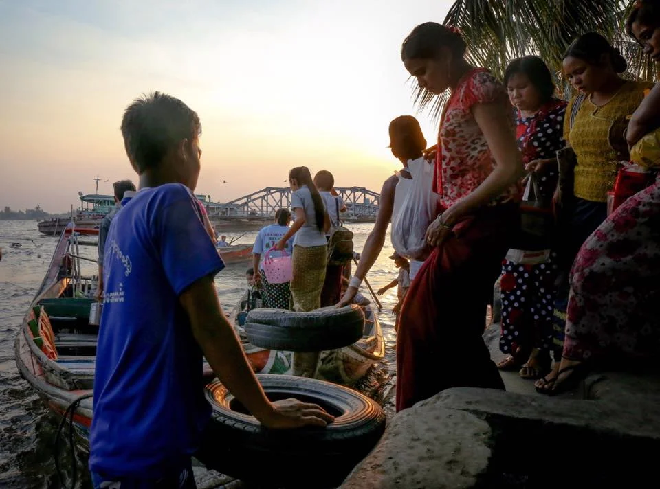 Sunset and rush hour coincide at the jetty. Yangon, Myanmar