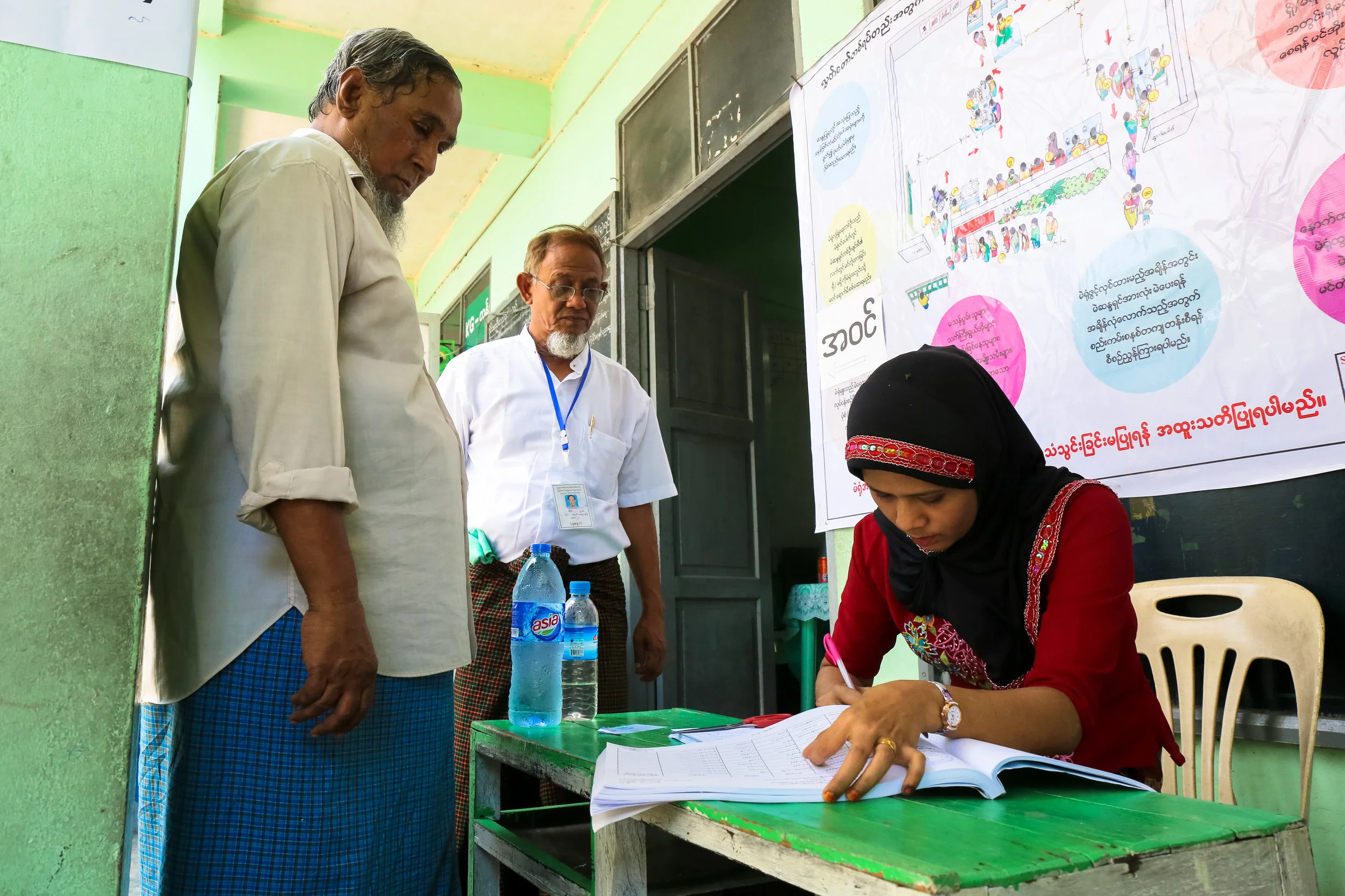 A woman takes notes on voting records in Yangon.