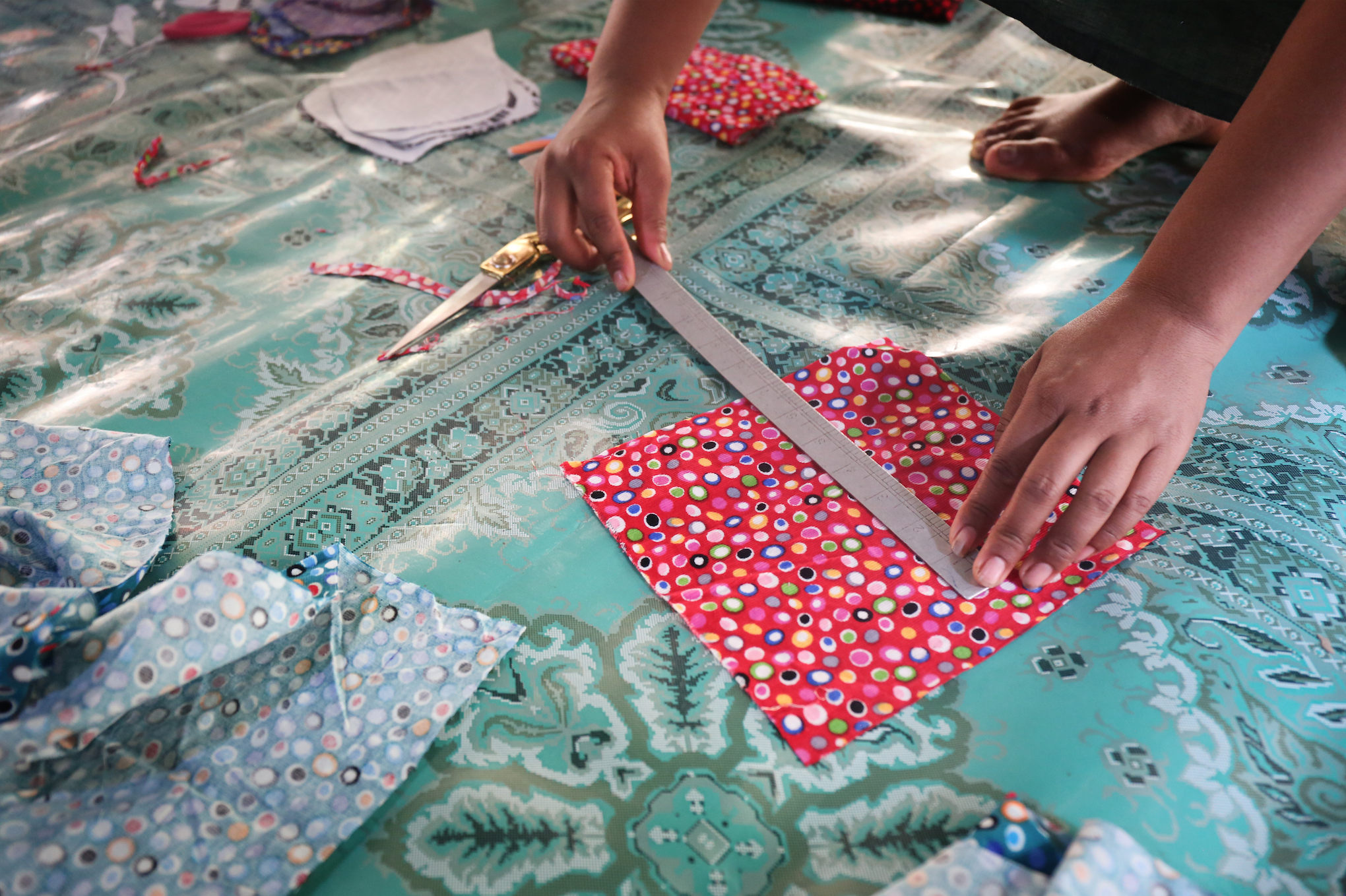 Women sew reusable menstrual pads. March 2018